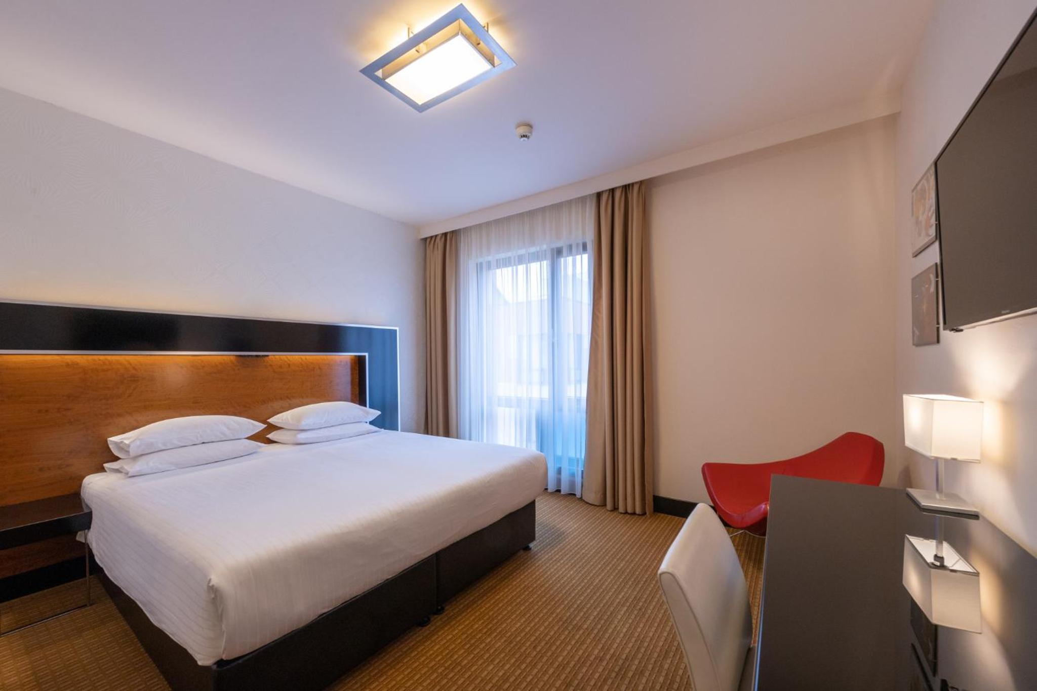 Relax in comfort in this modern hotel room.