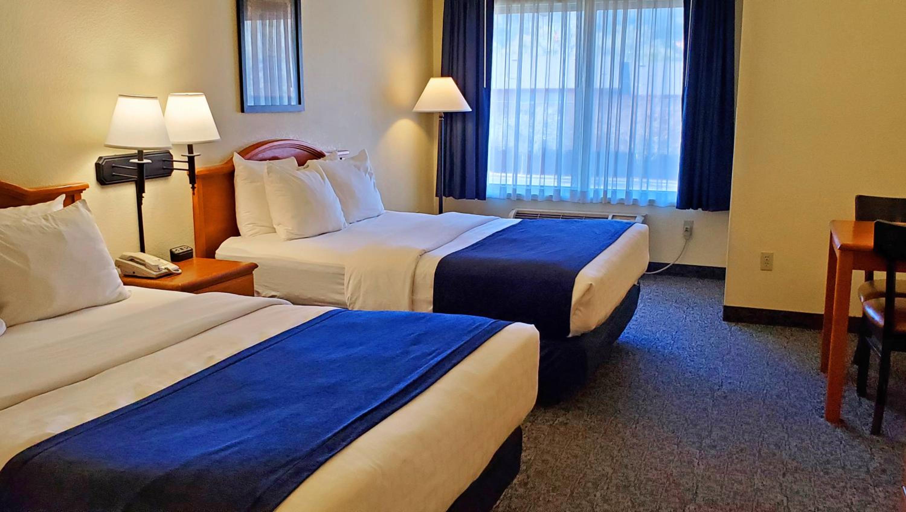 Hotel room with two double beds and blue runners