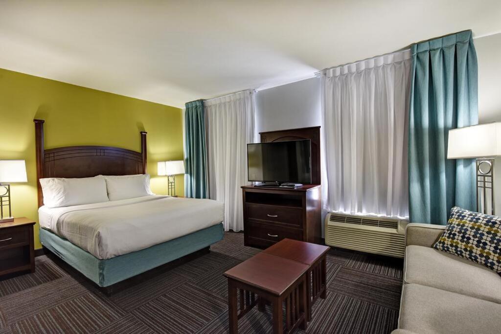 hotel room with a king size bed and a flat screen tv