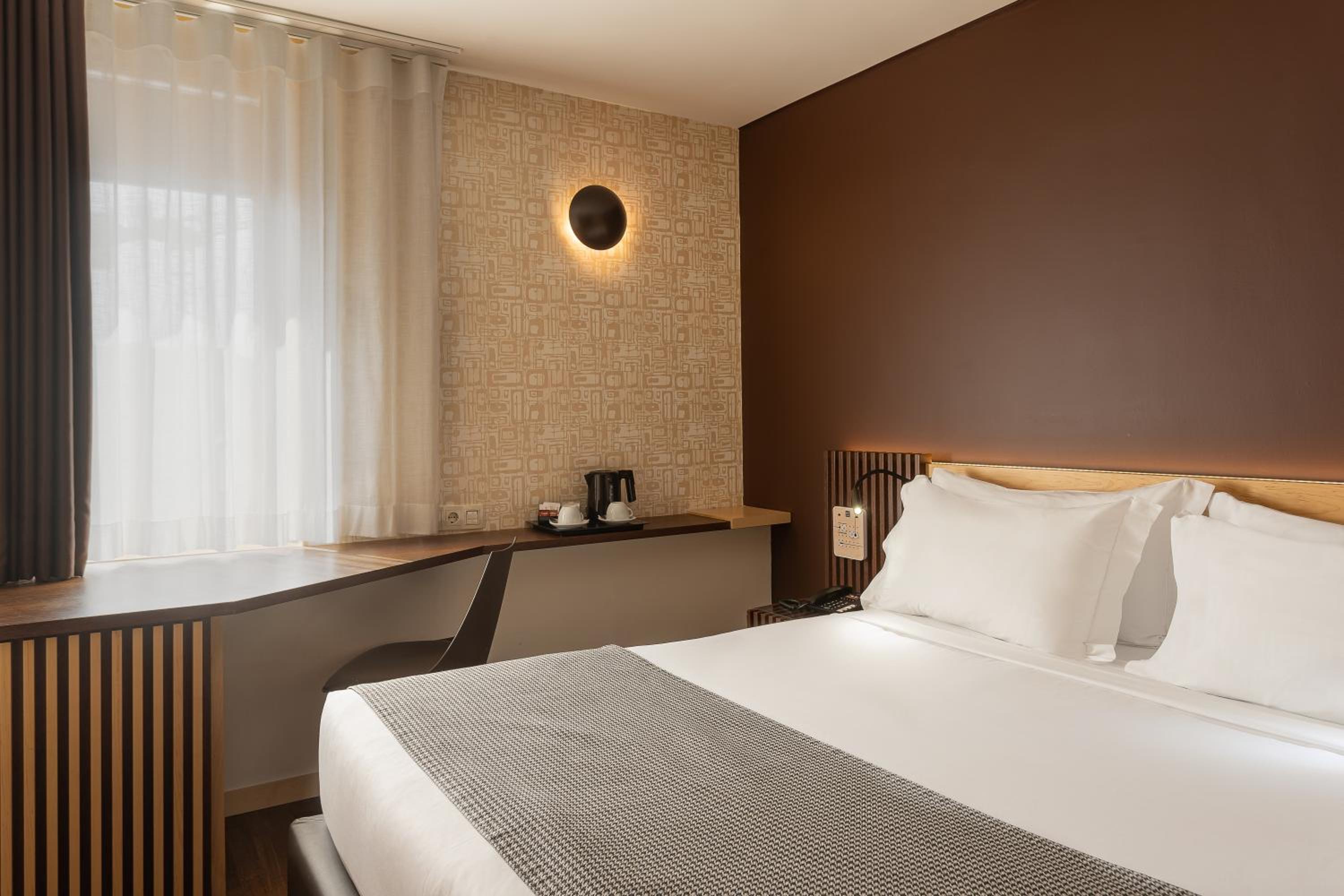 Relax in this cozy, modern hotel room retreat.