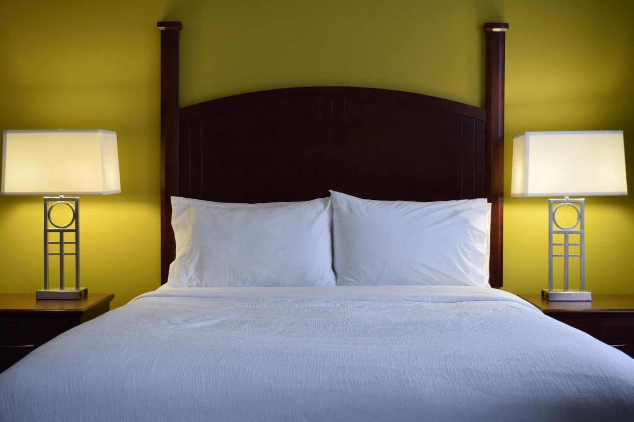 bed with two lamps on either side of the bed