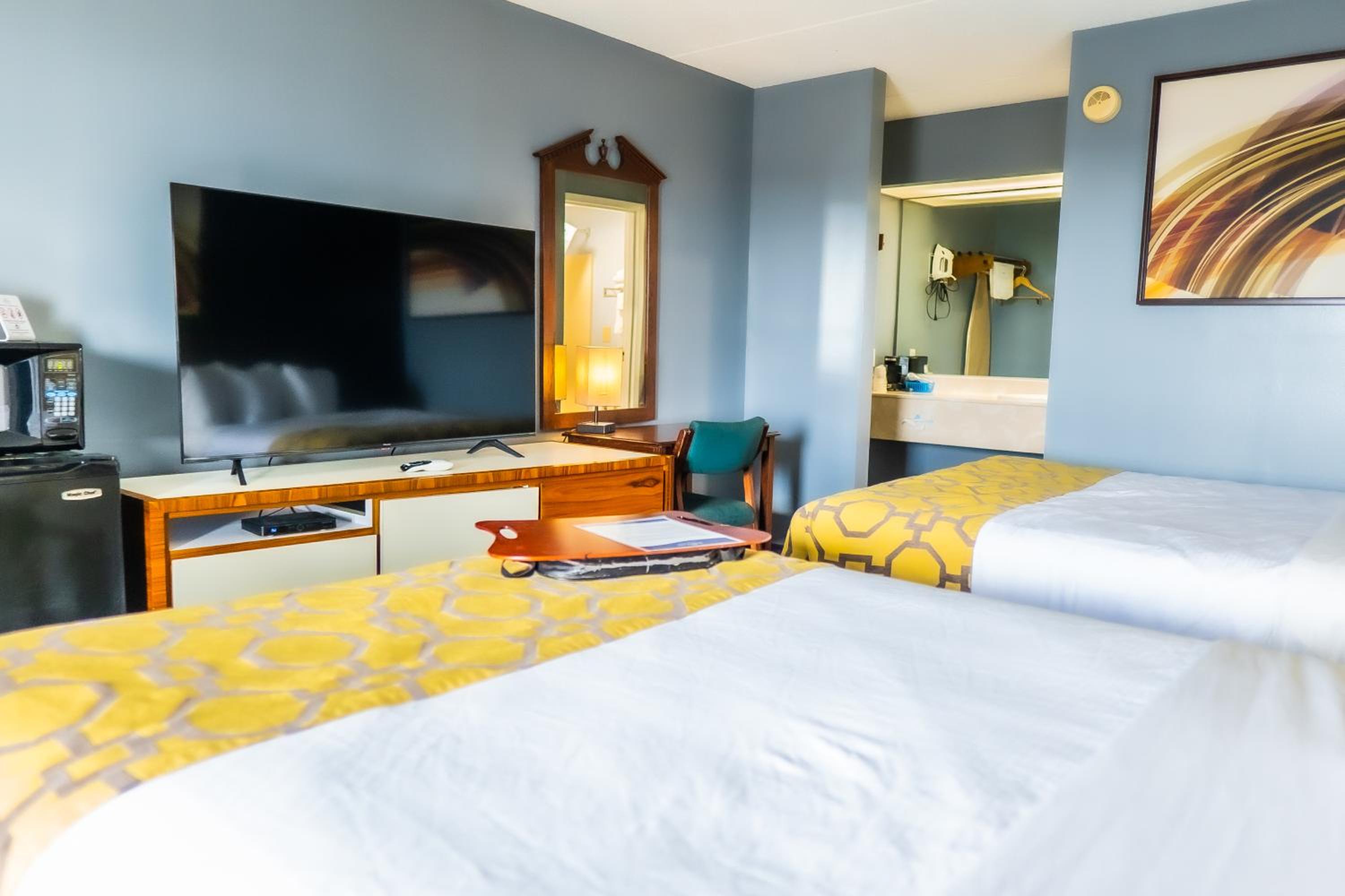 hotel room with two beds and a flat screen tv