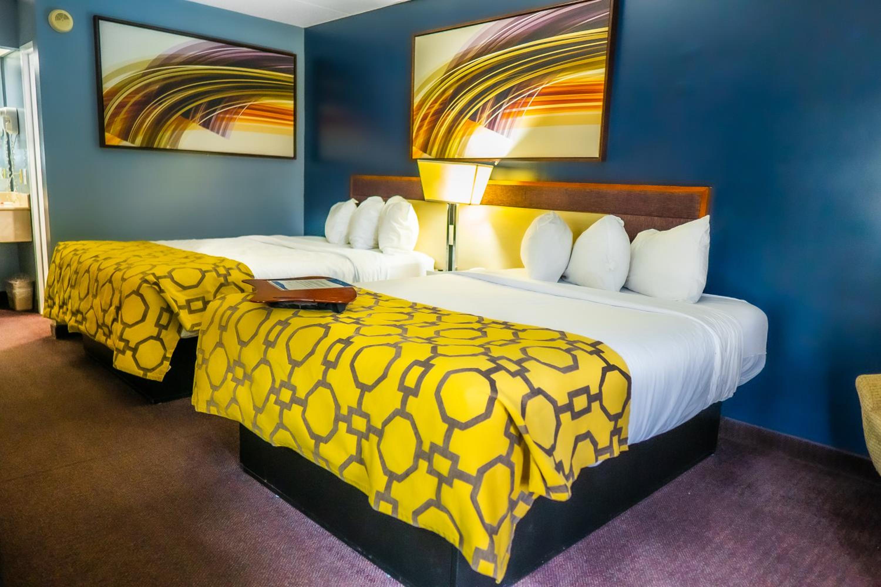 hotel room with two beds and a painting on the wall