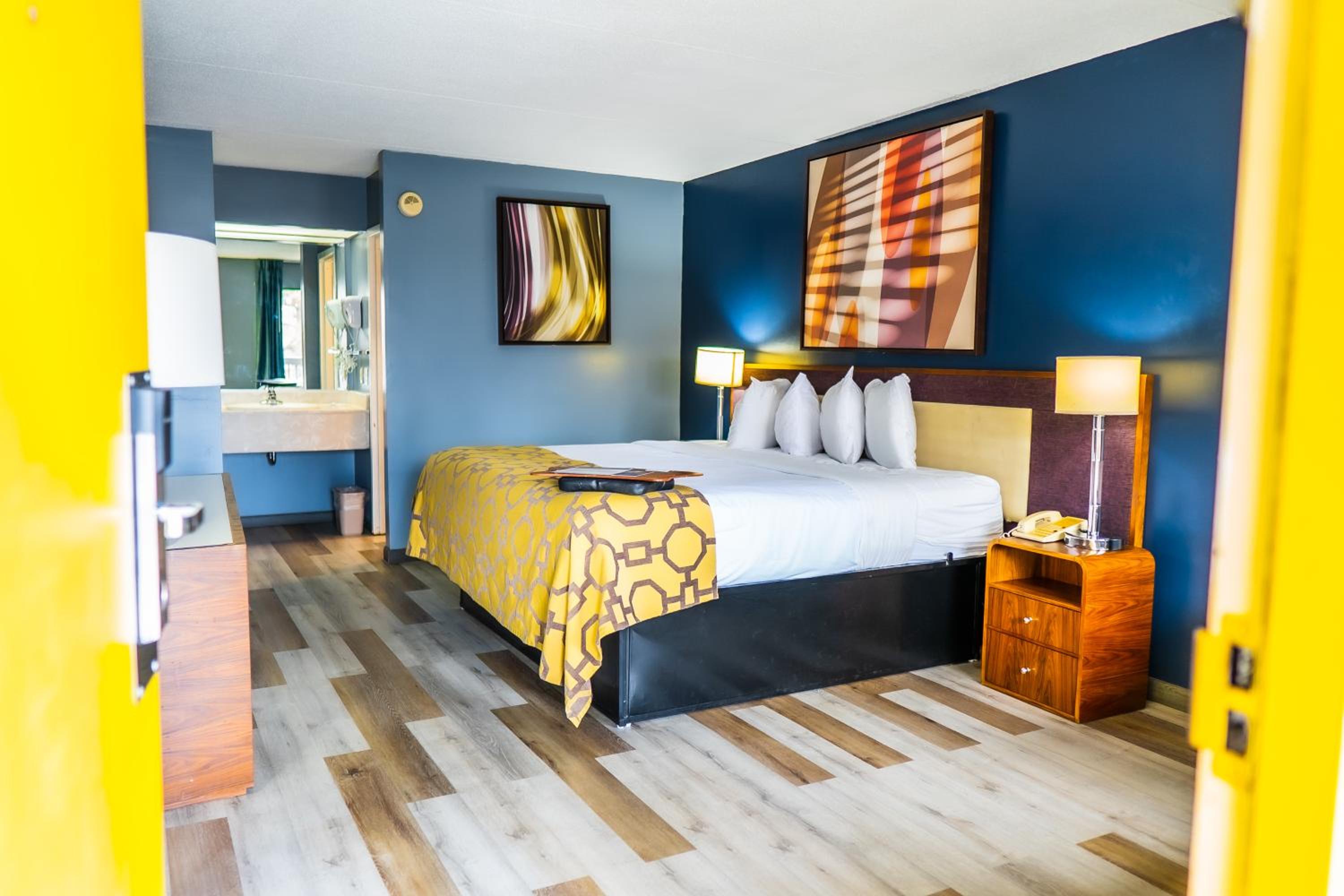 hotel room with blue walls and wood flooring?