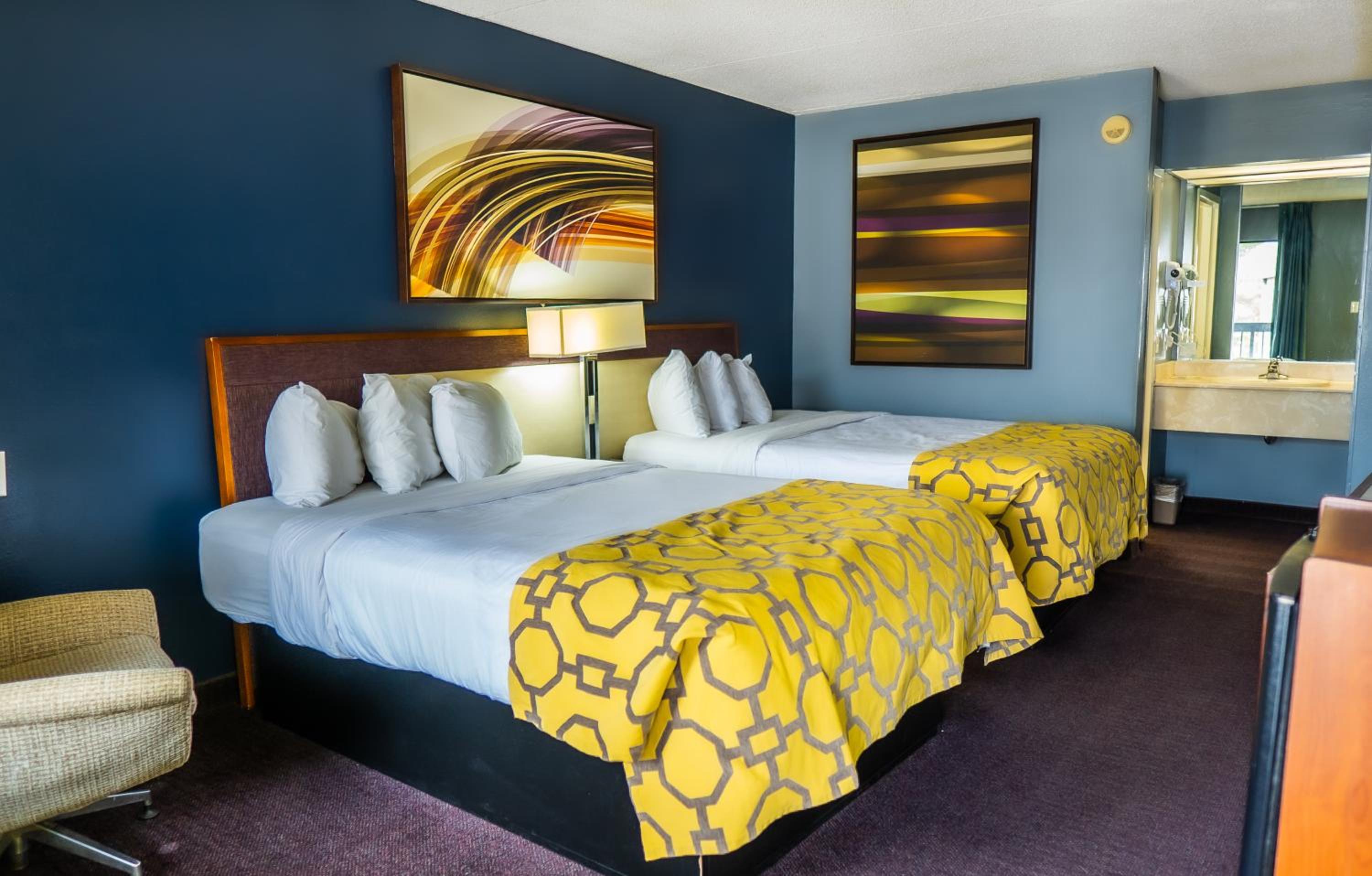 hotel room with two beds and a painting on the wall