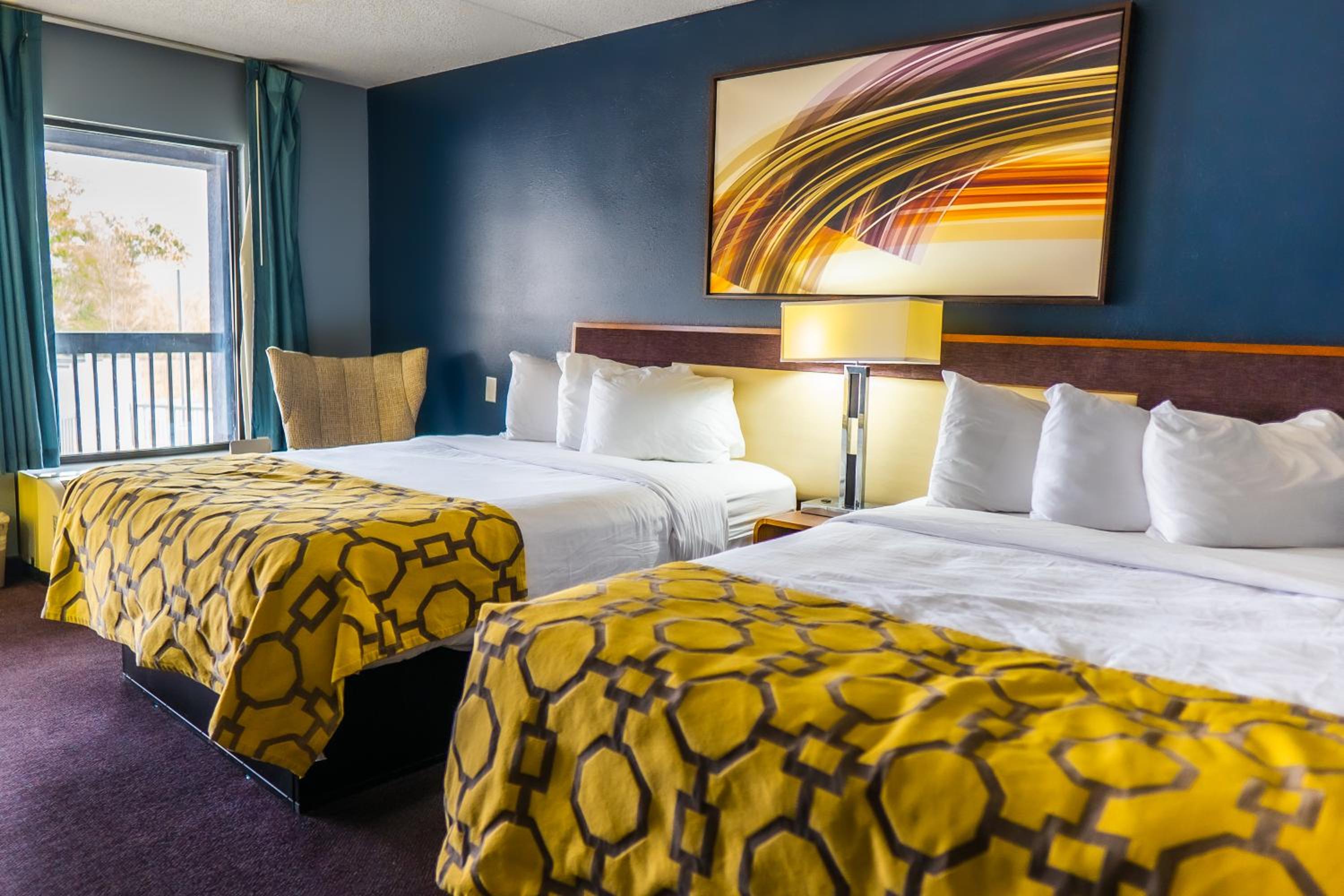 hotel room with two beds and a painting on the wall