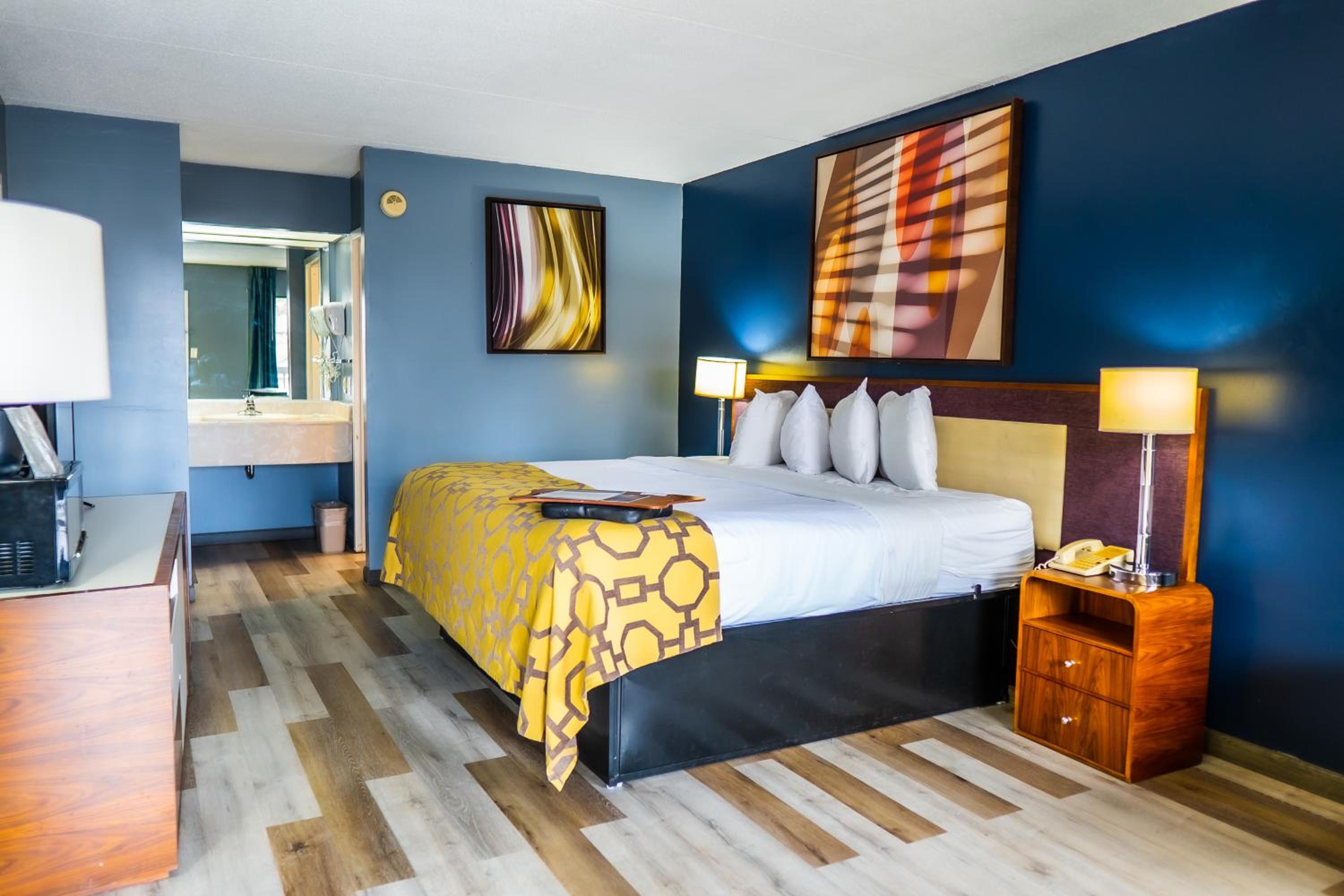 hotel room with blue walls and wood flooring?