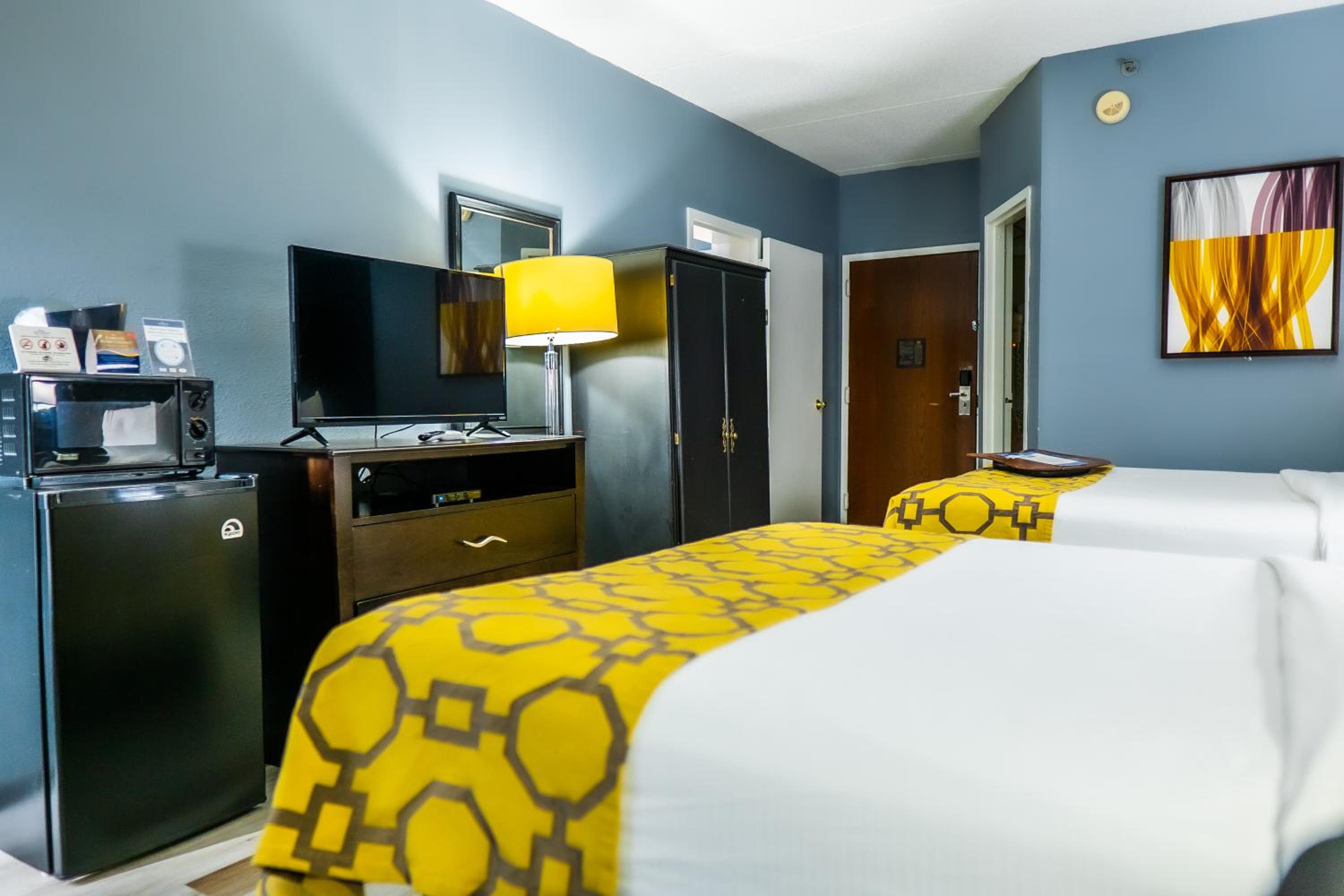 hotel room with two twin beds and a mini fridge