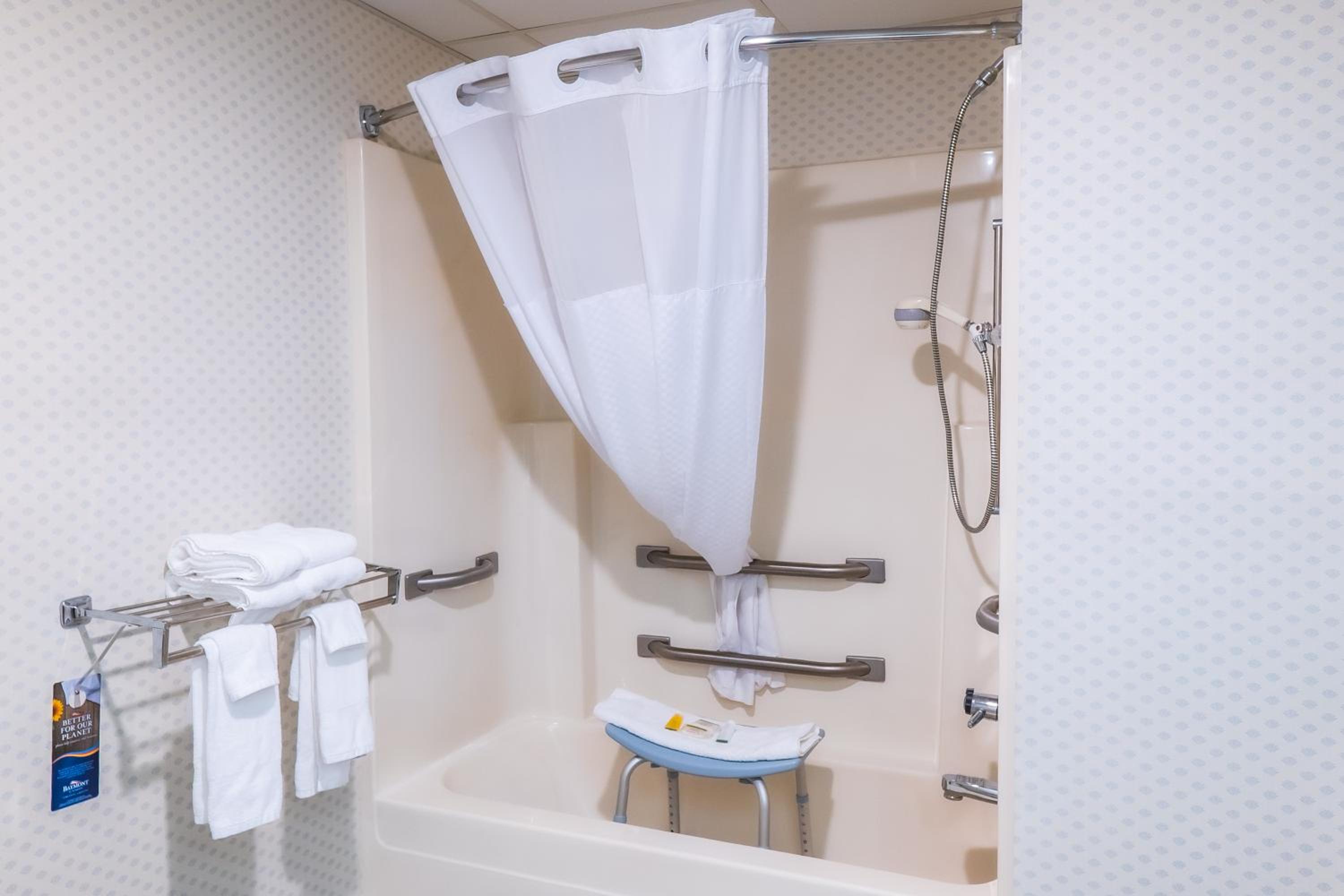 bathtub with a shower curtain hanging from the ceiling