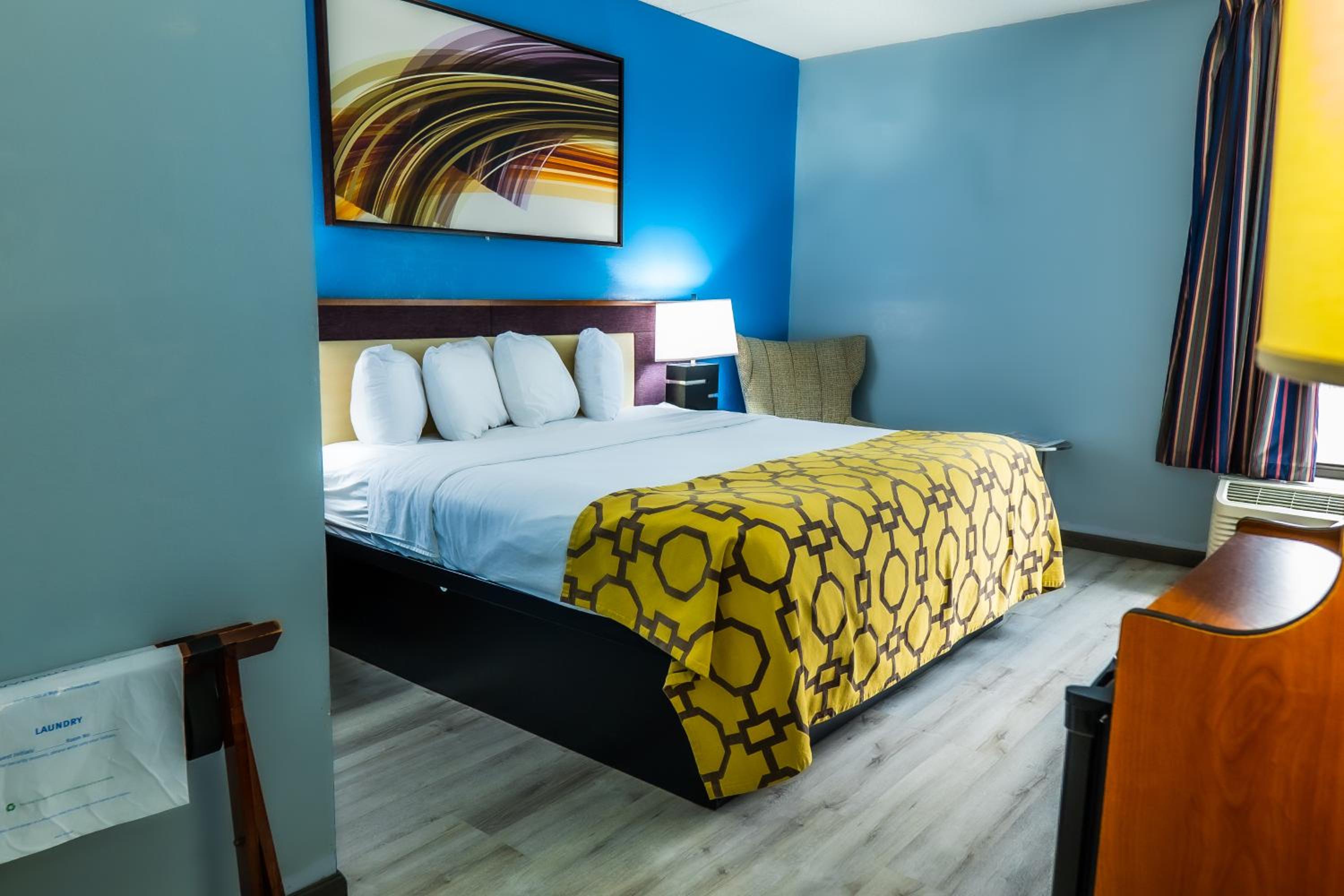 hotel room with blue walls and a yellow bedspread