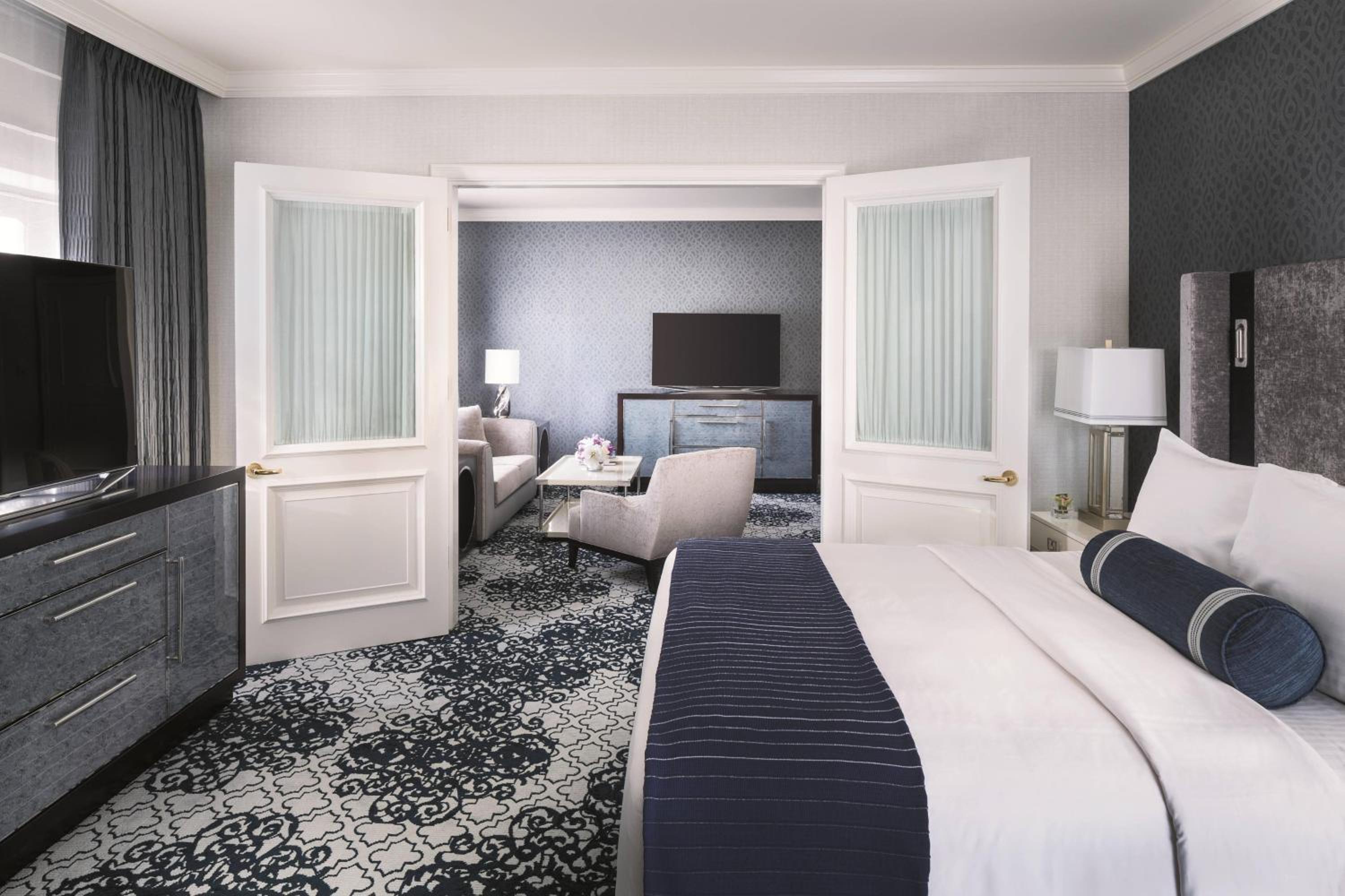 hotel room with a large bed and a flat screen tv
