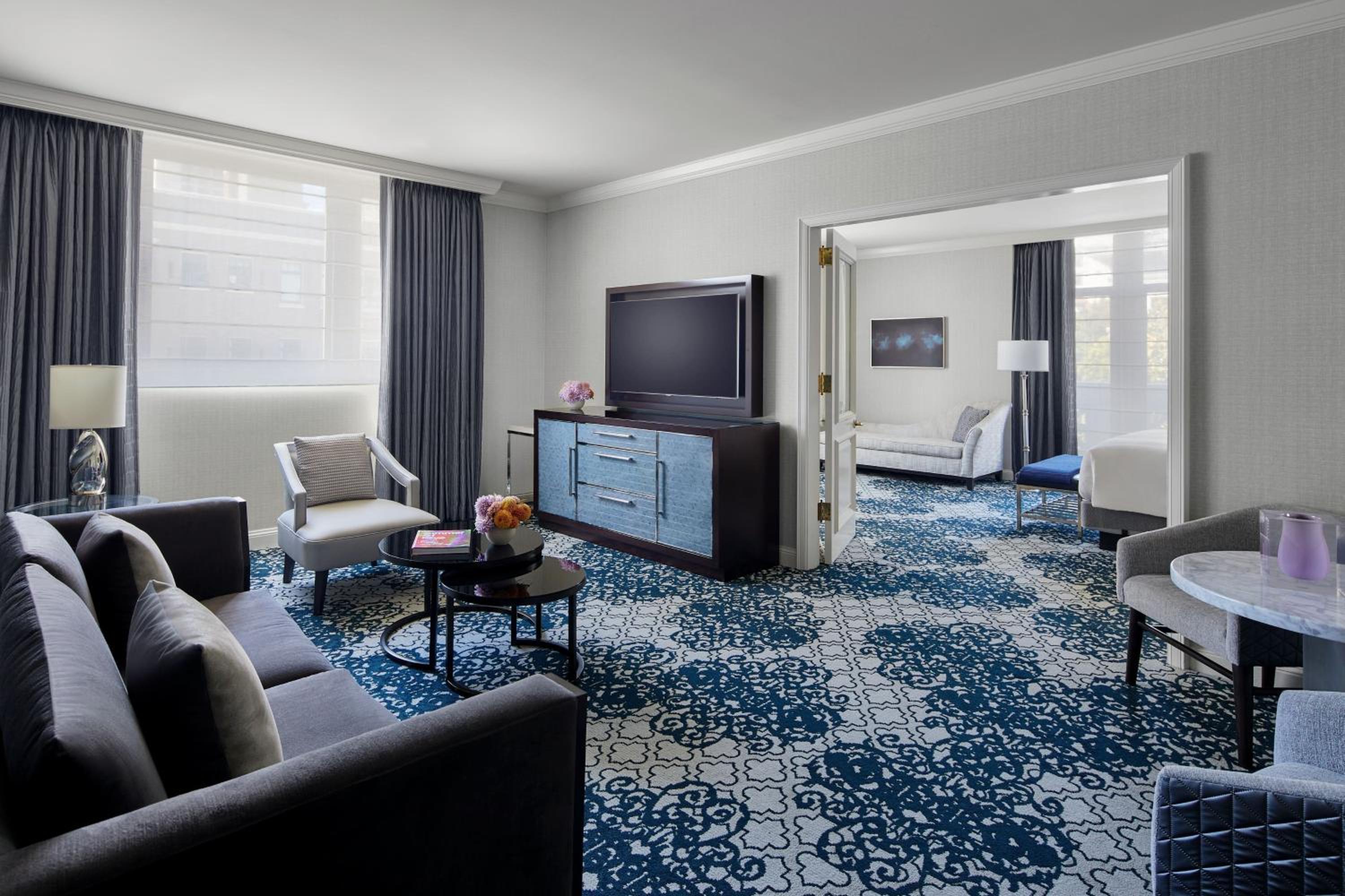 living room with blue carpeting and a large flat screen tv