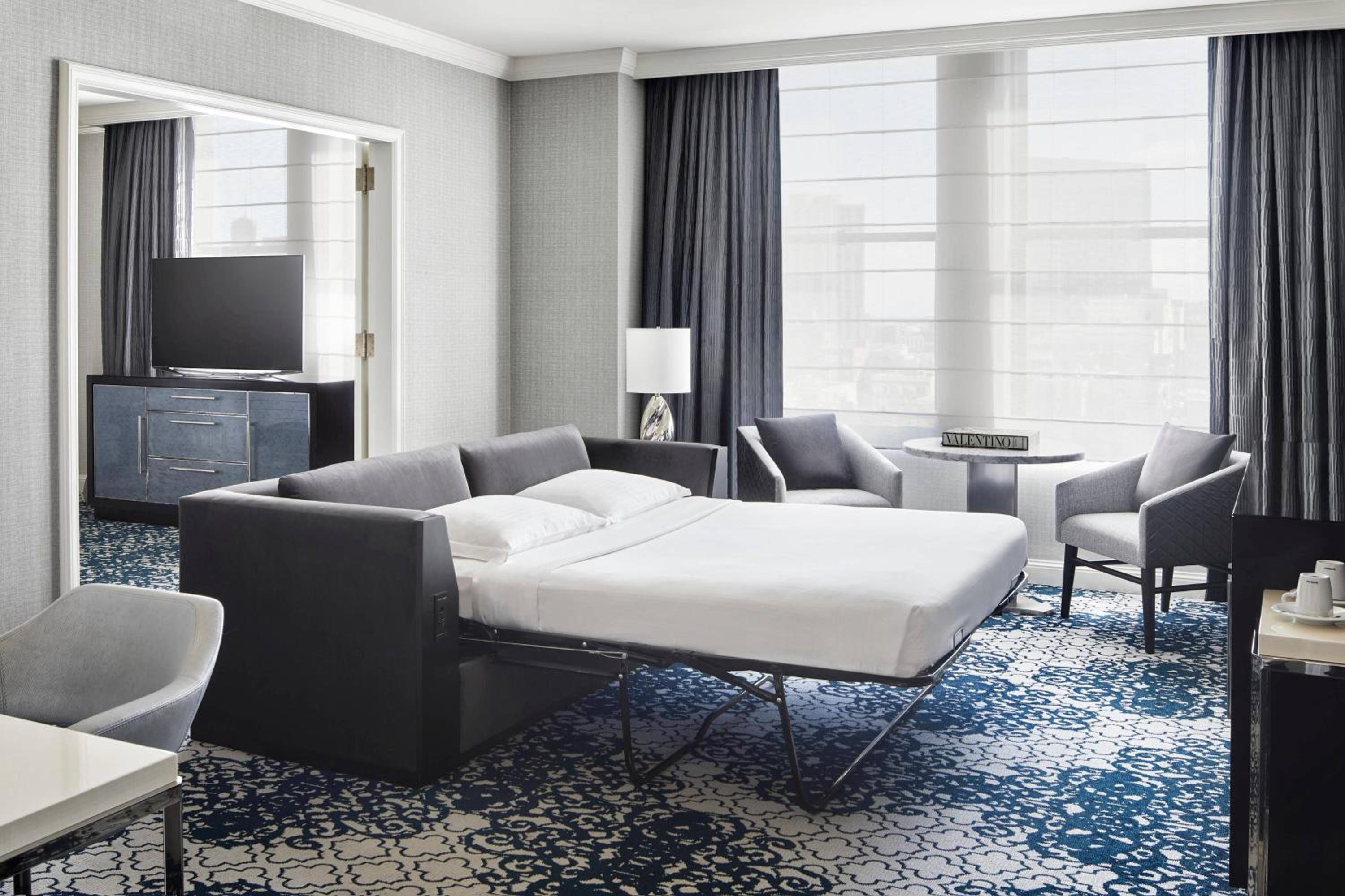 hotel room with a king size bed and blue carpet