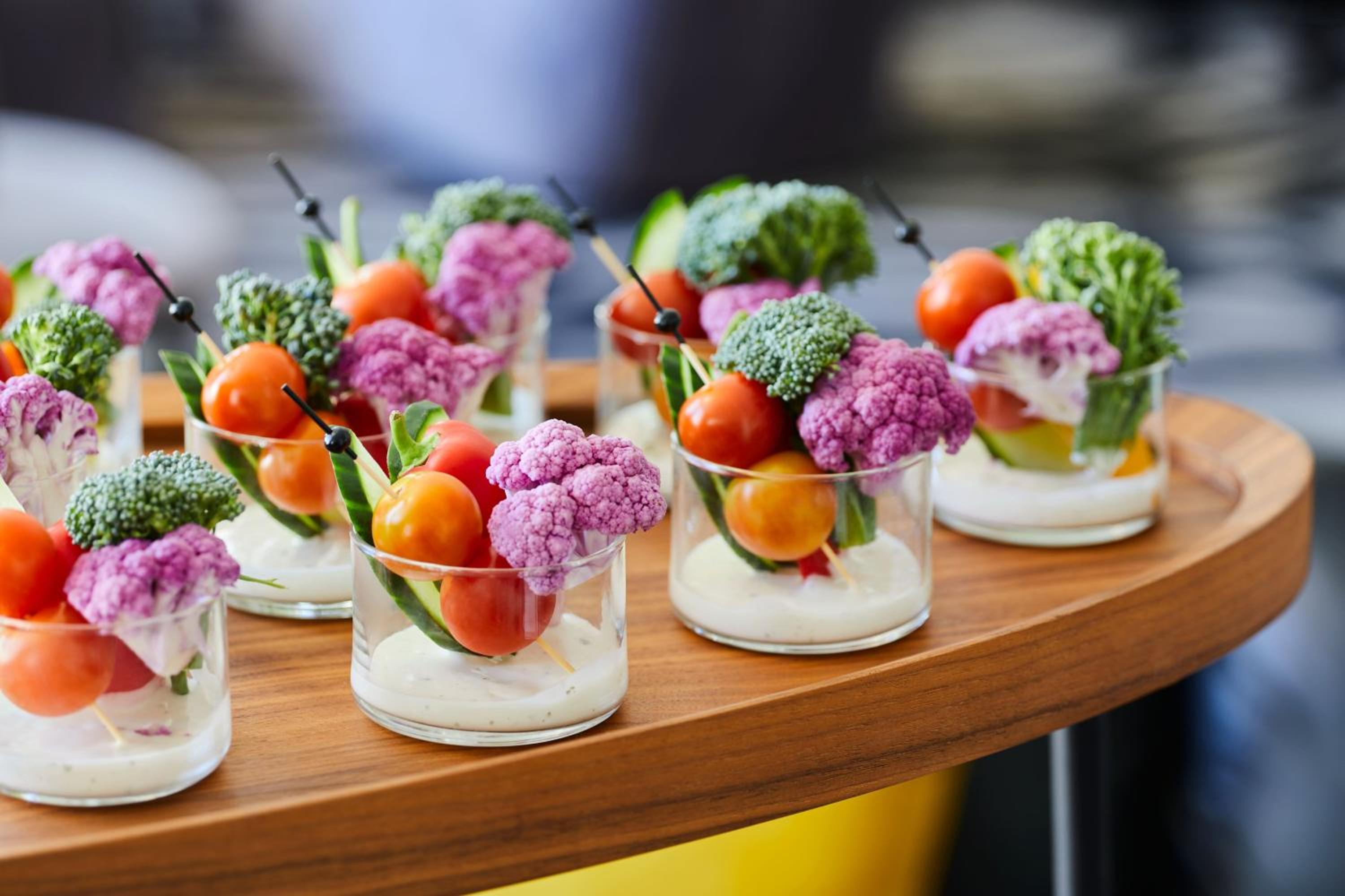 platter of appetizers with tomatoes, broccoli, and cauliflower