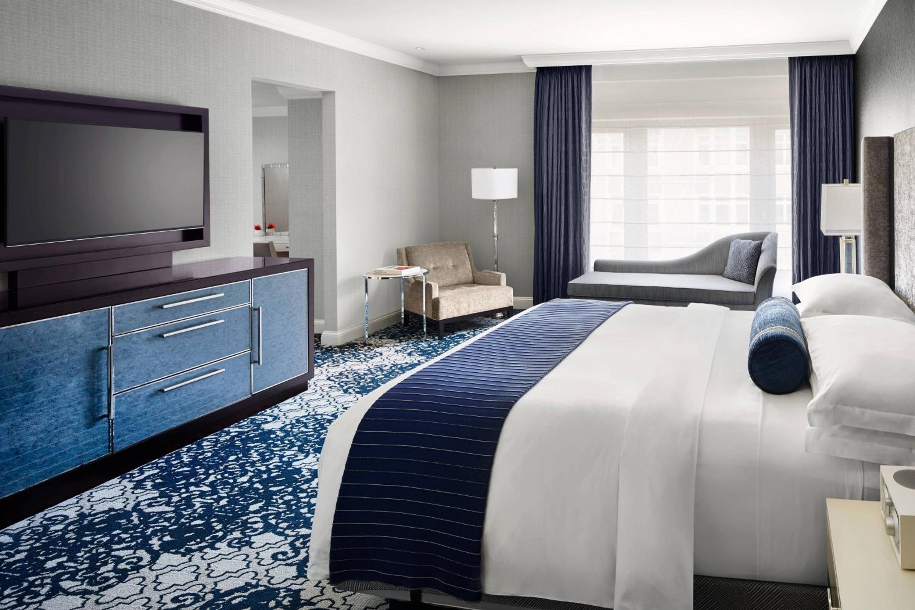 hotel room with a large bed and a flat screen tv