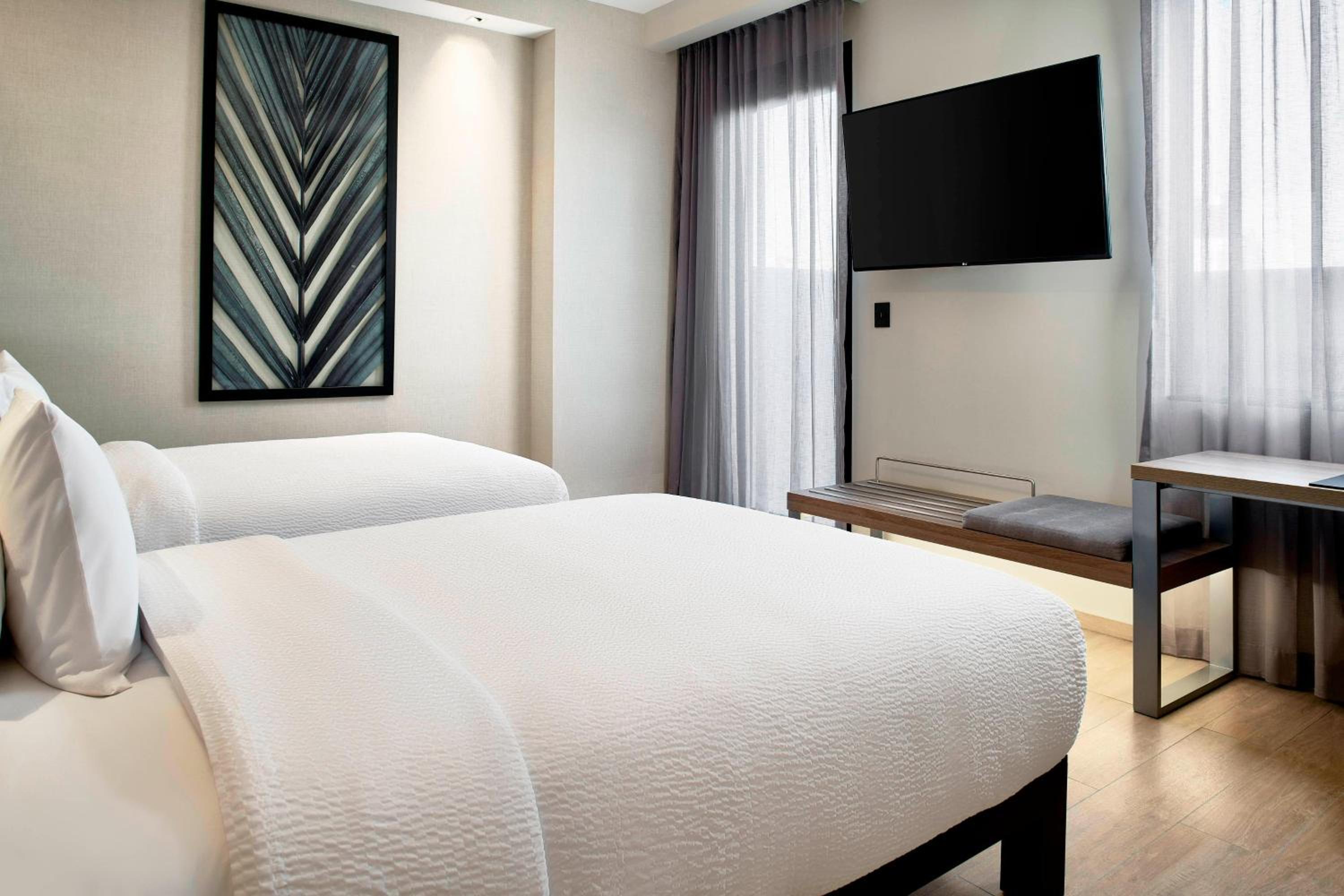 Guest Room with Two Double Beds and City View