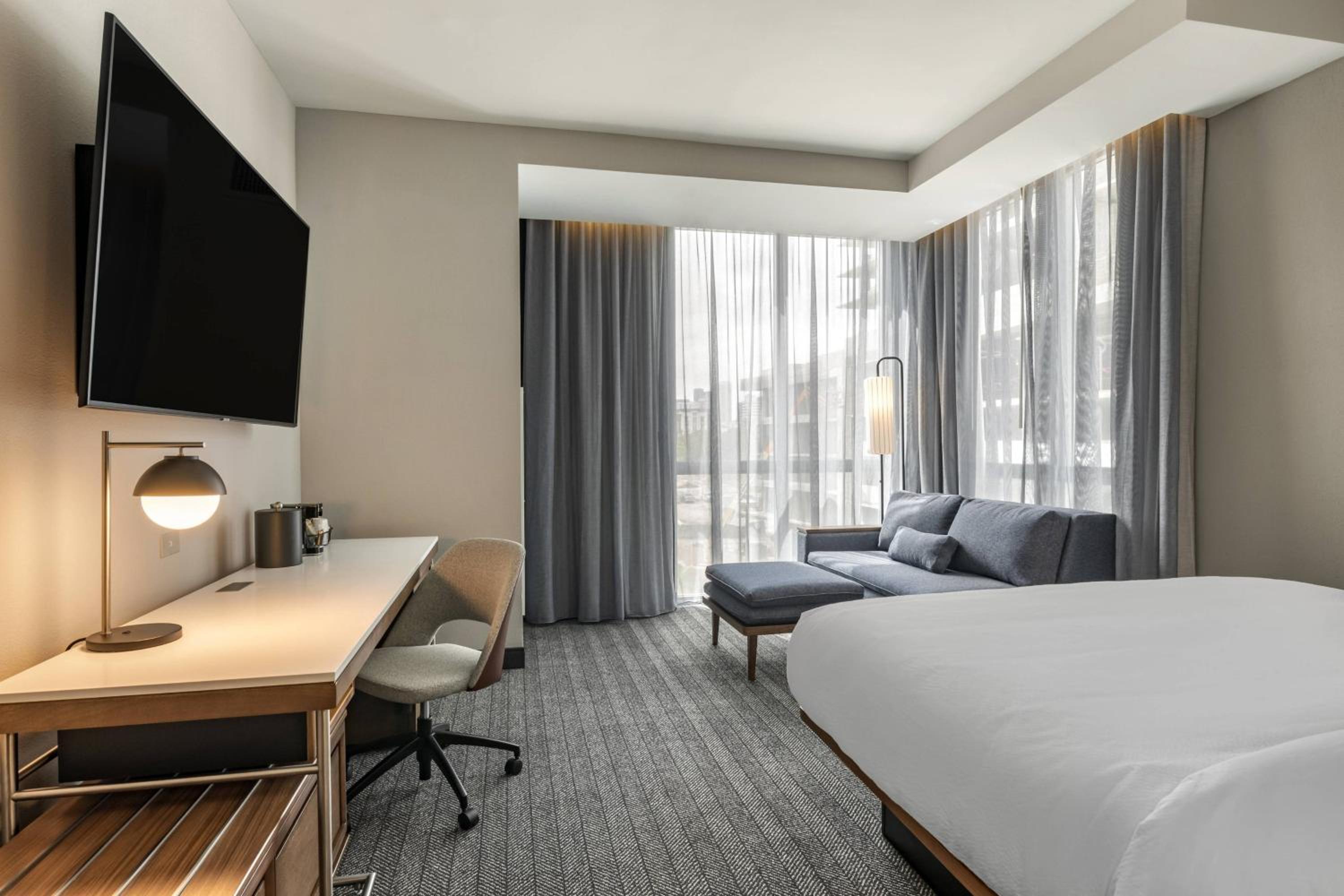 Corner room with king bed, sofa bed and city view