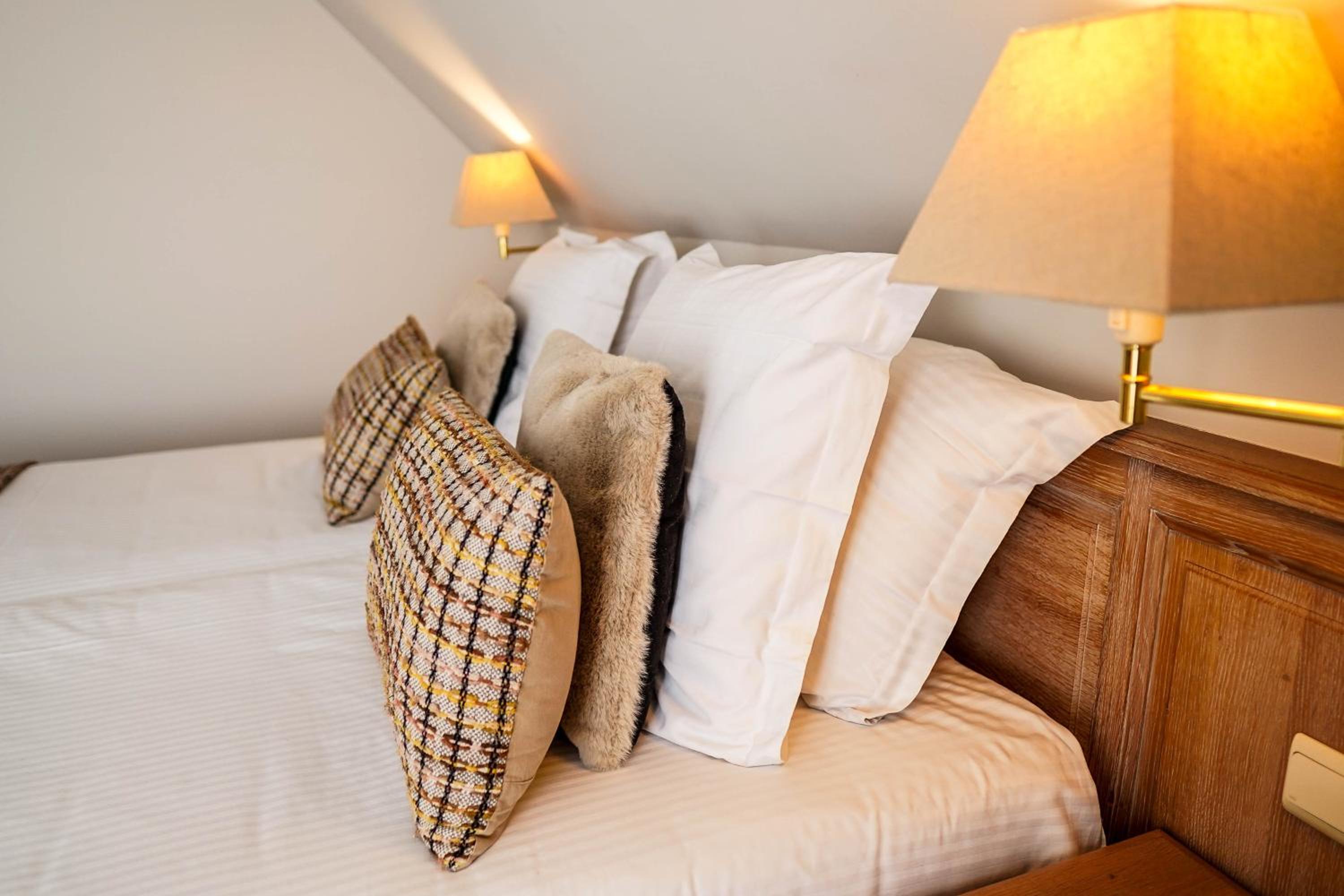 photo of a bed with pillows and blankets on it