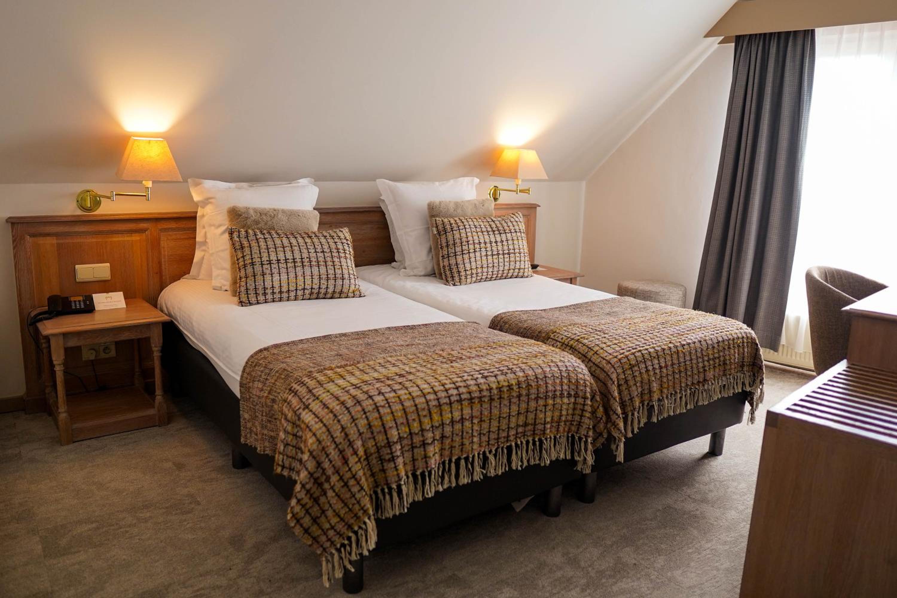 bedroom with two beds and a desk in the corner