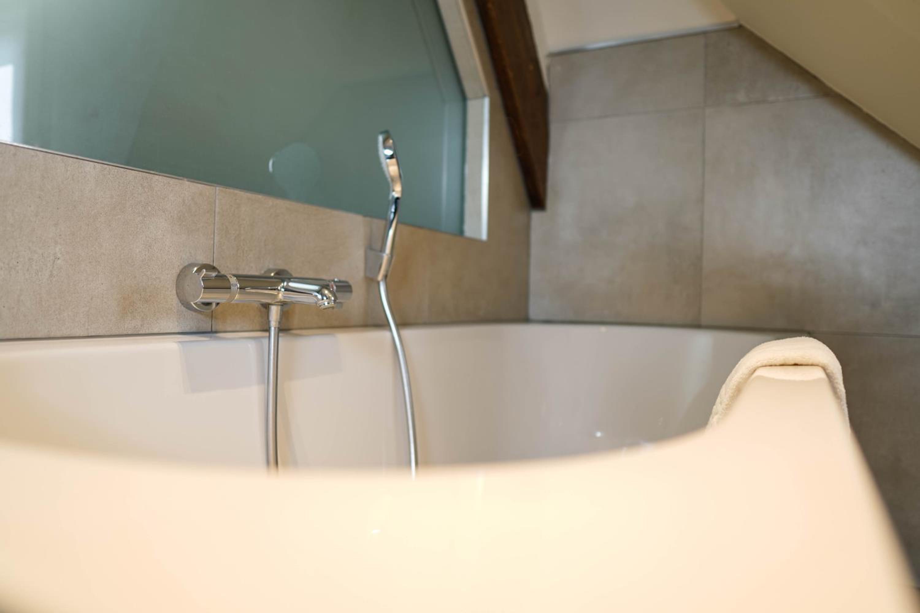 bathtub with a faucet attached to it