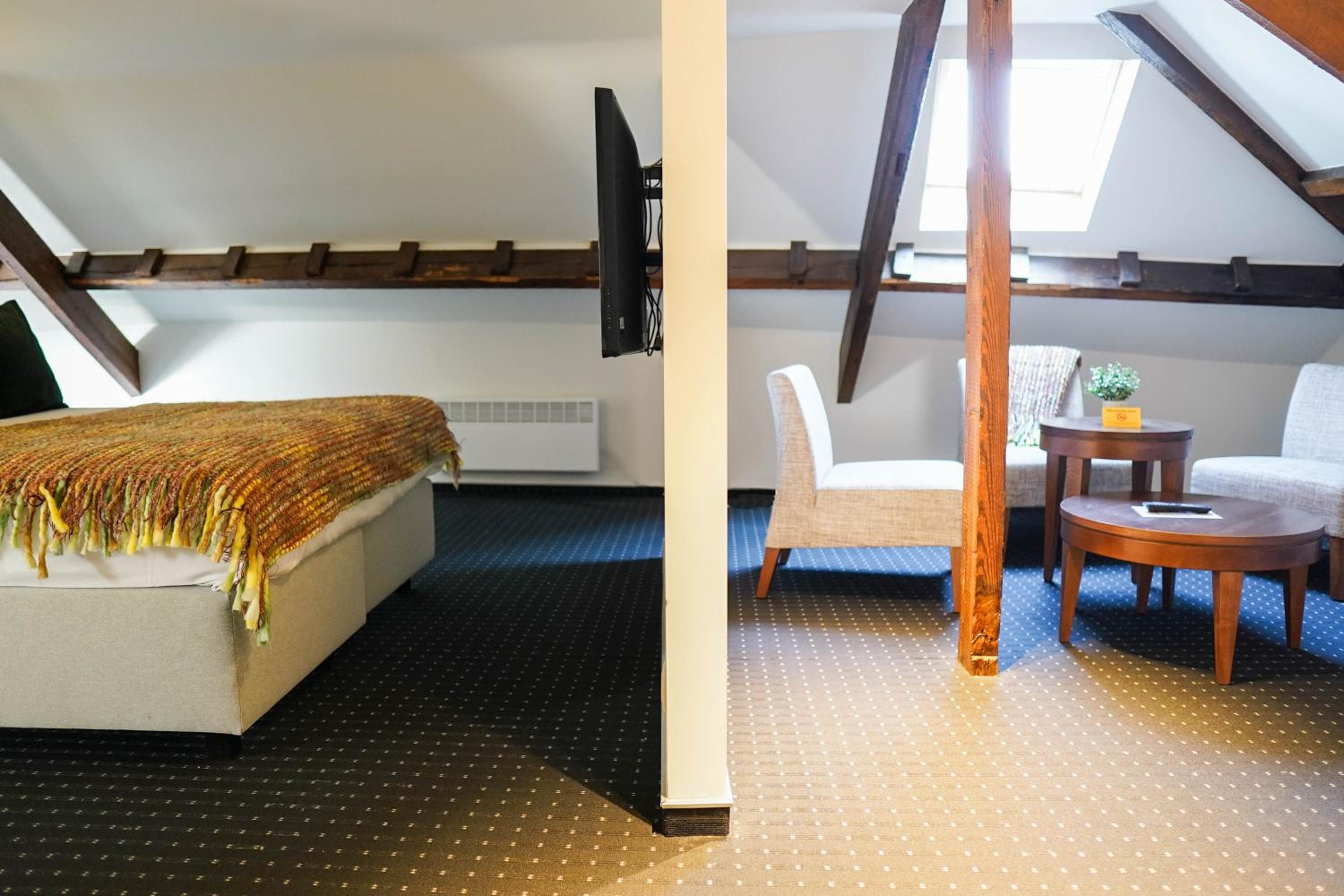 room with a bed, chair, and table in it