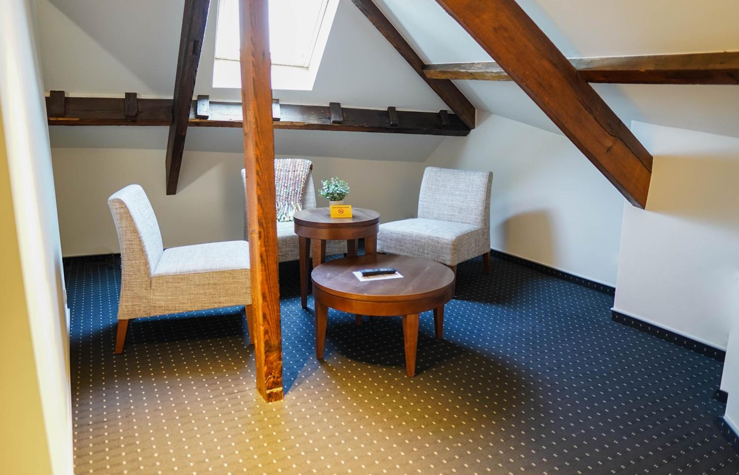 corner of a room with two chairs and a table