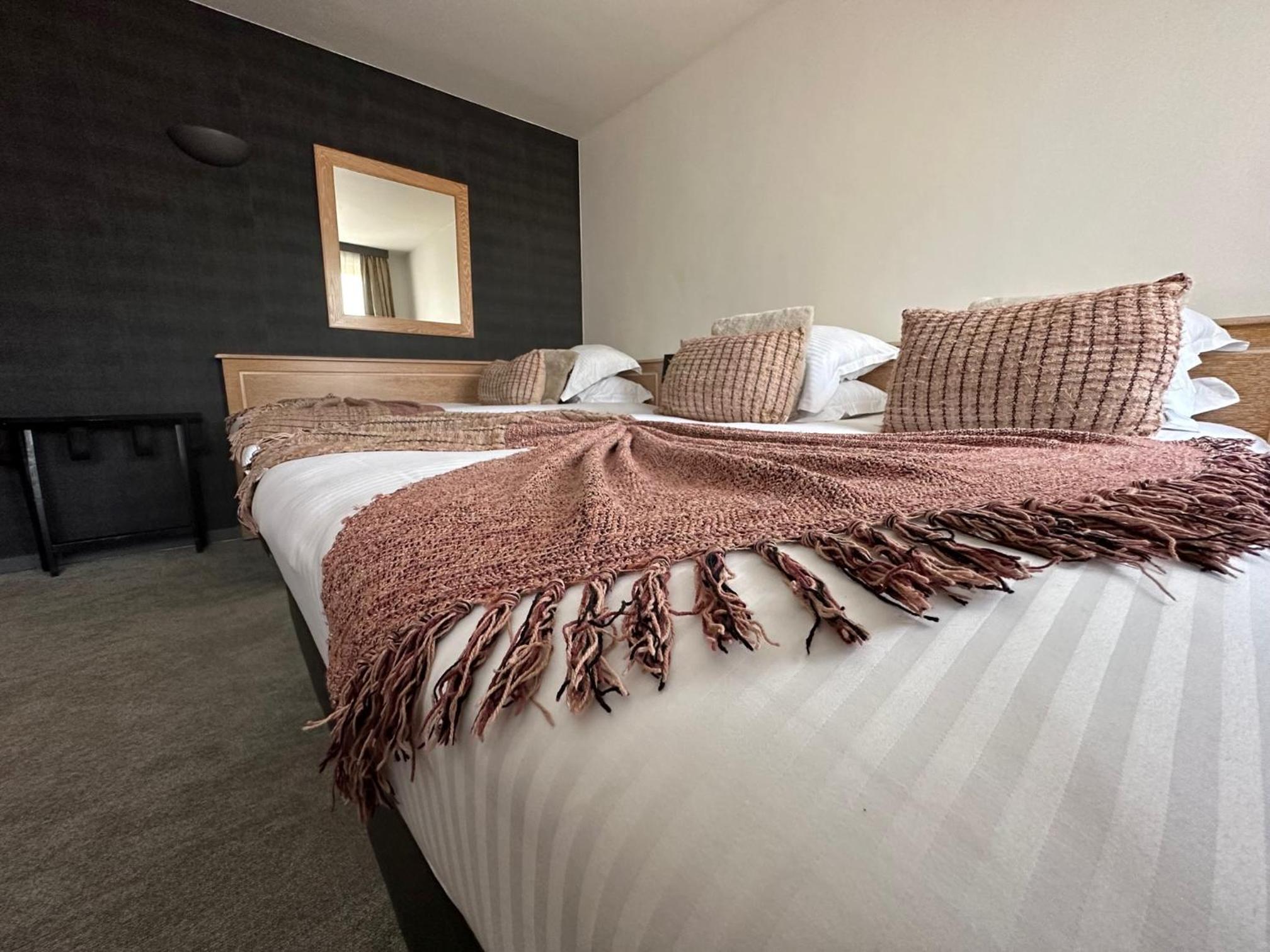 bed with a blanket and pillows on top of it