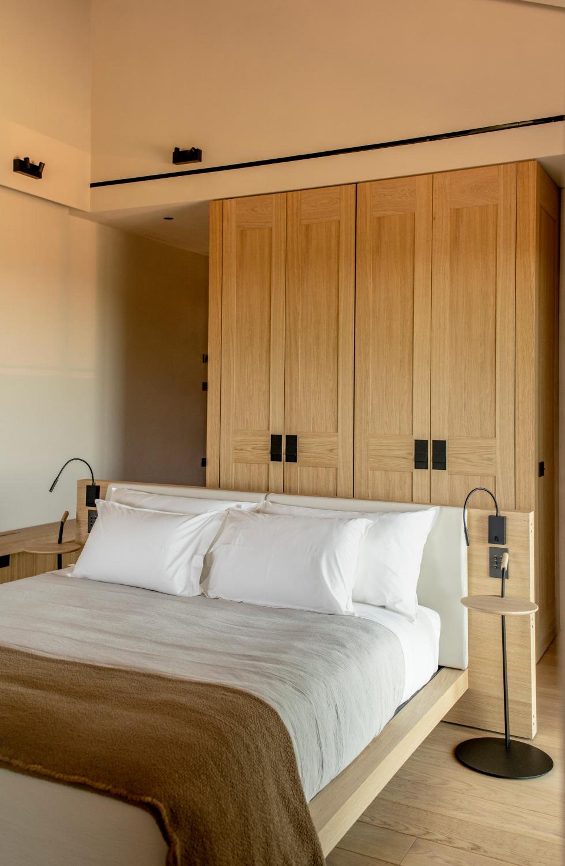 bedroom with wood paneled walls and white bedding