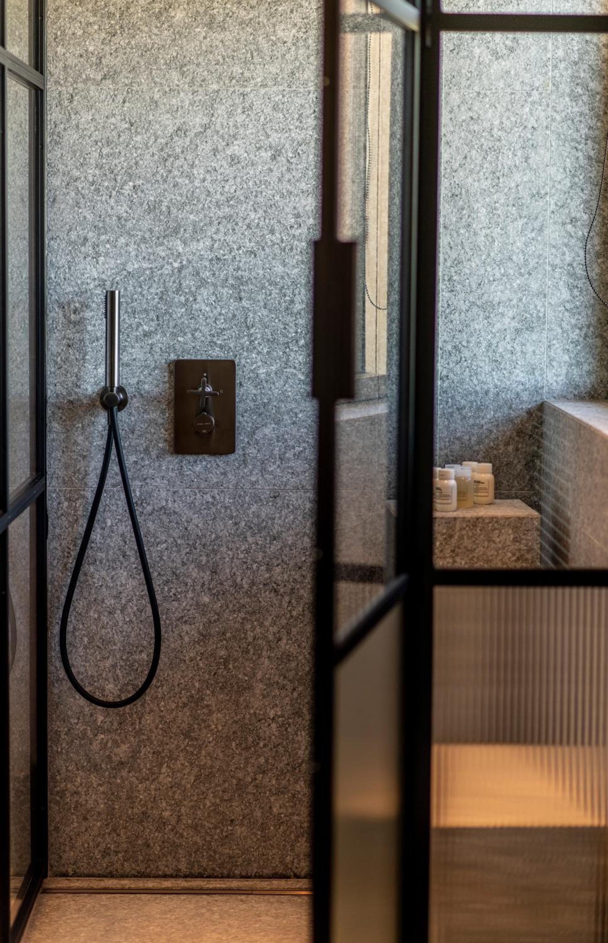 walk - in shower with a glass door to the outside