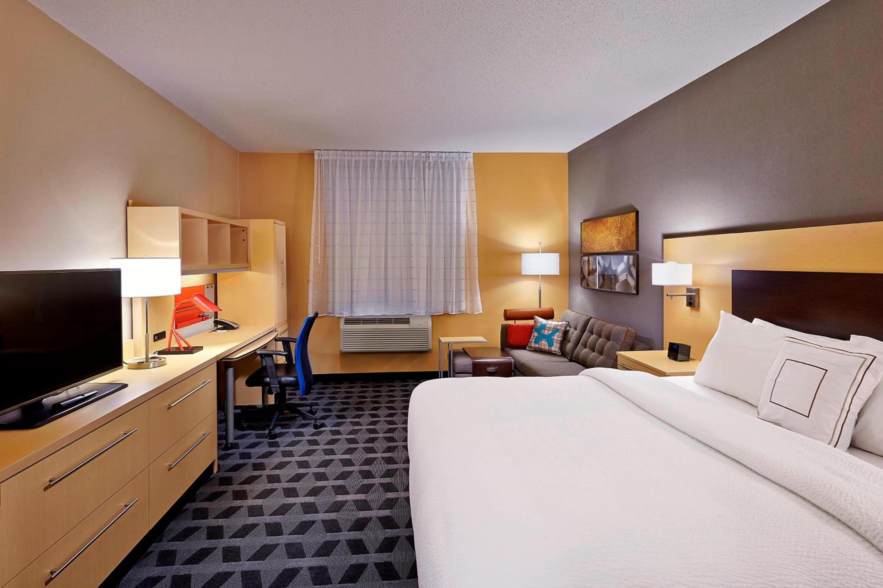 hotel room with a king size bed and a flat screen tv