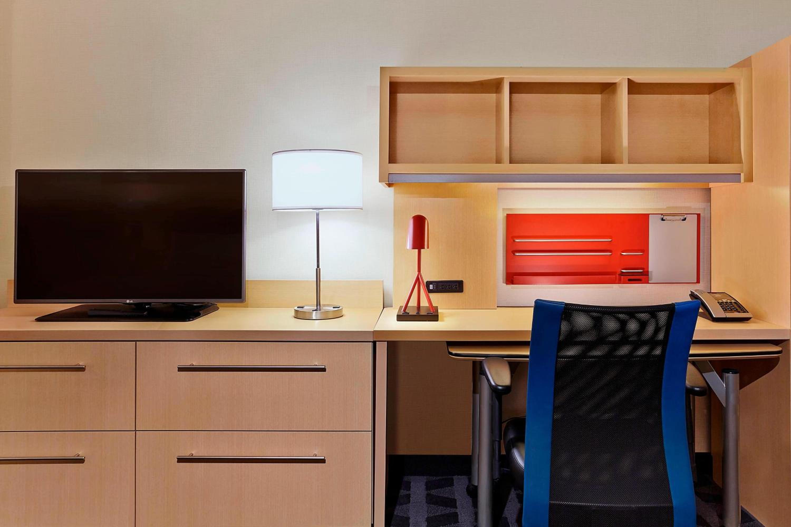 desk with a computer and a lamp in the corner