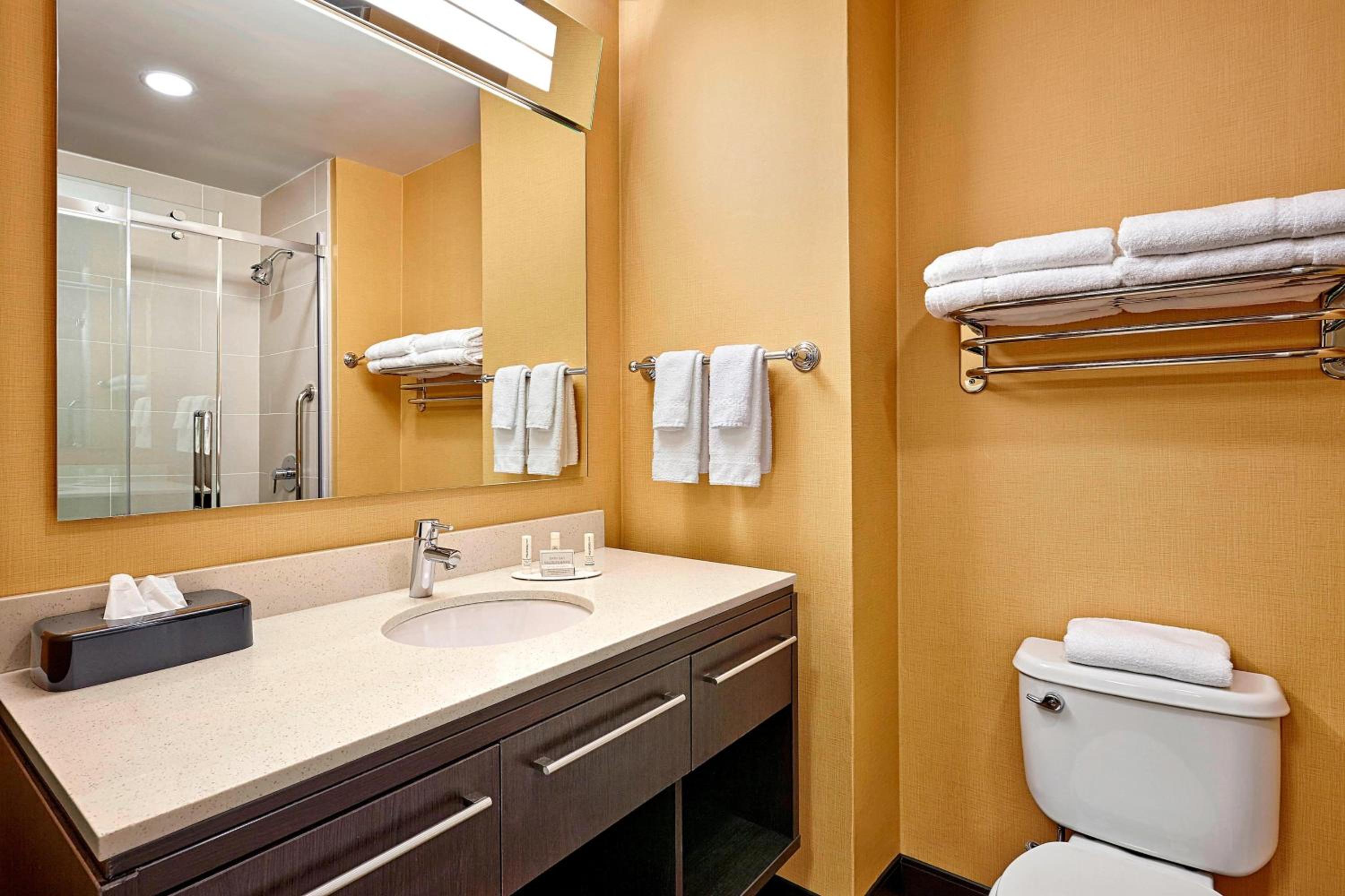 bathroom with a sink, toilet, and towel rack