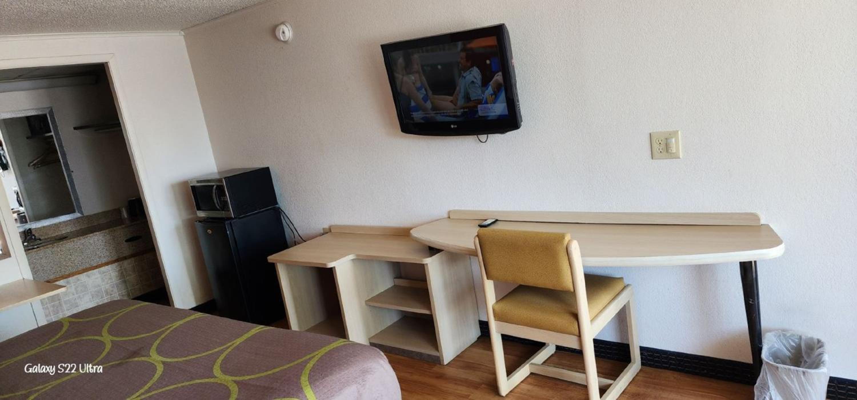 hotel room with a flat screen tv on the wall