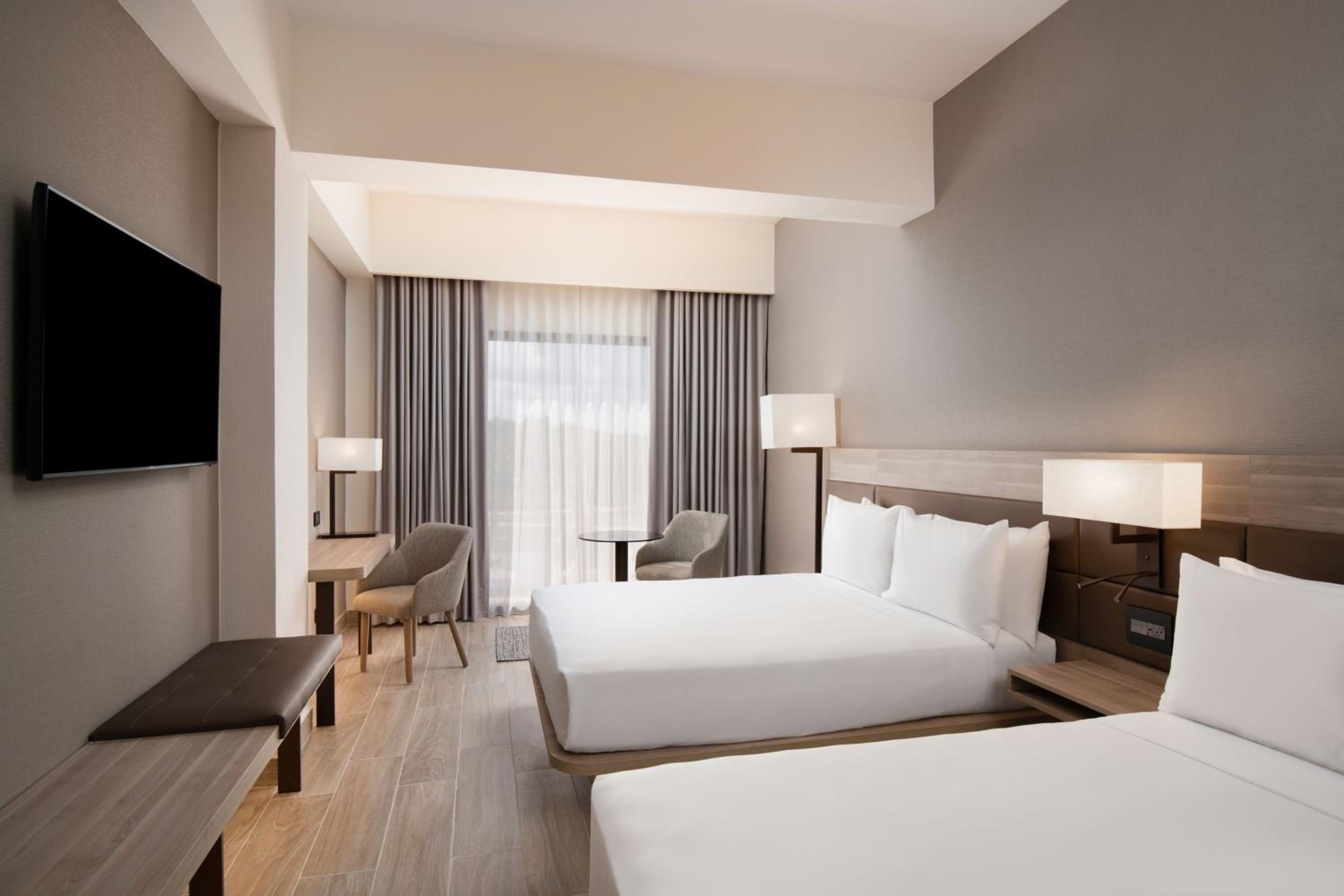 Deluxe Queen Room with Two Queen Beds and Pool View - Photo 1