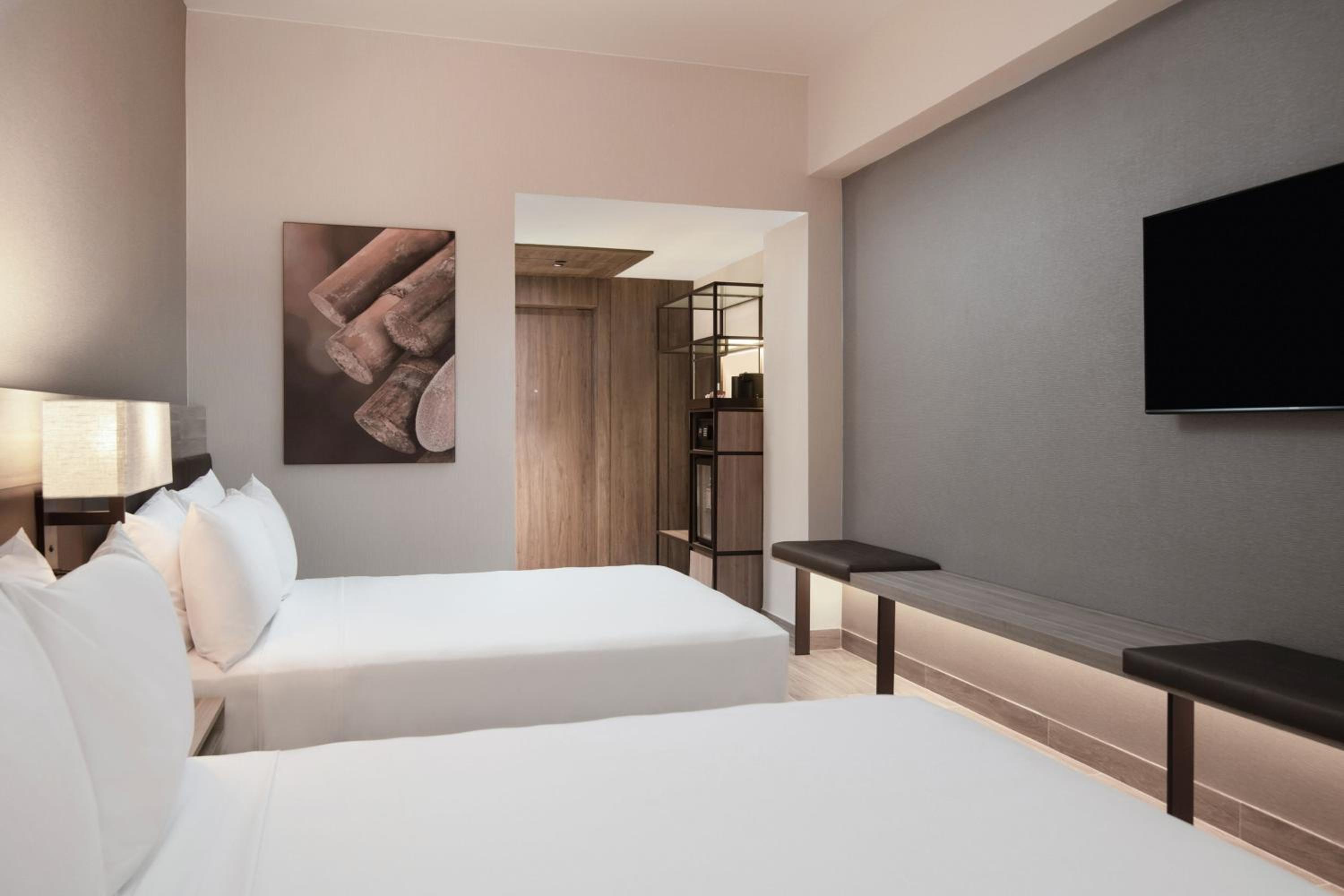 Deluxe Queen Room with Two Queen Beds and Pool View - Photo 2