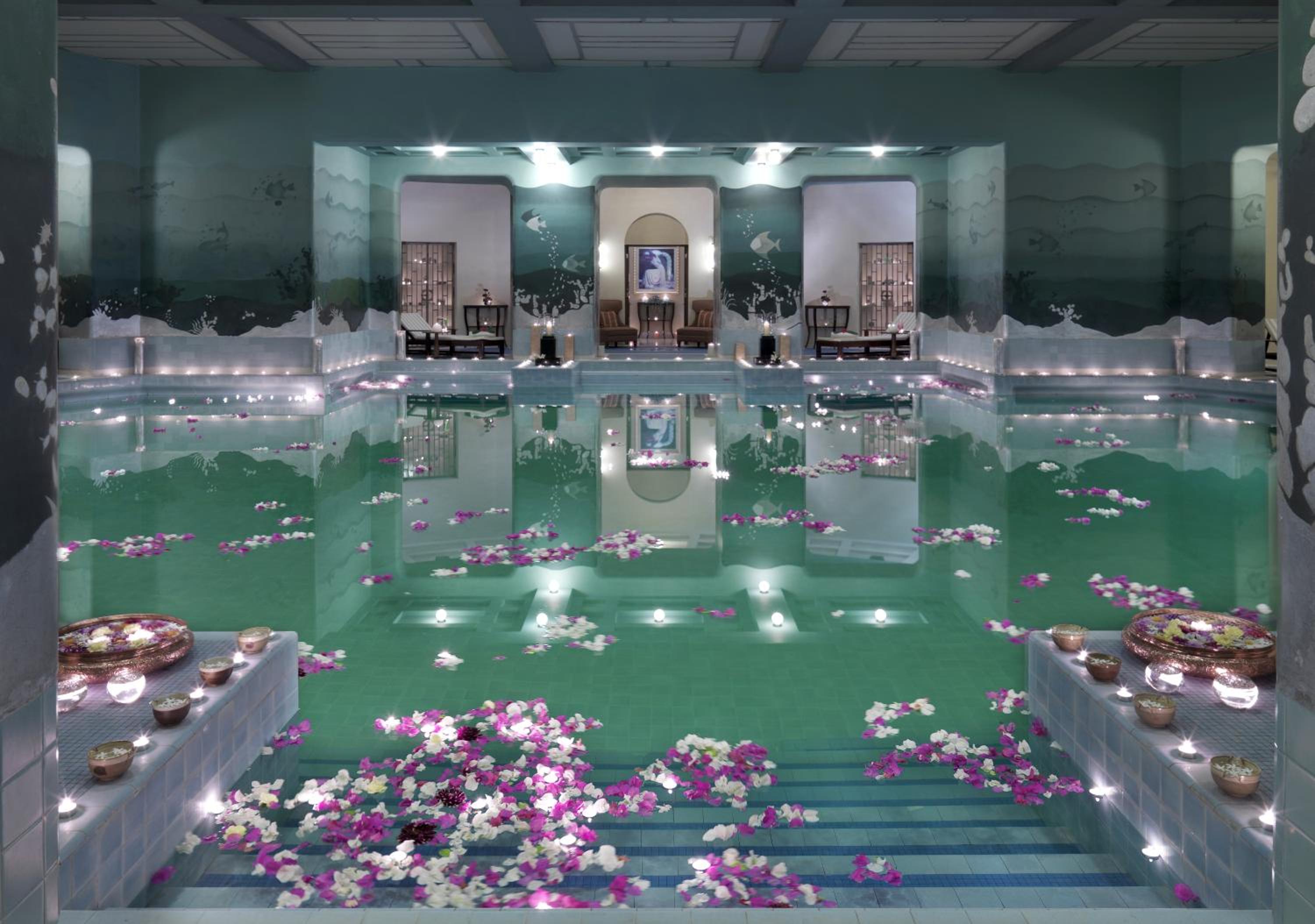 pool with candles and flowers in the middle of it