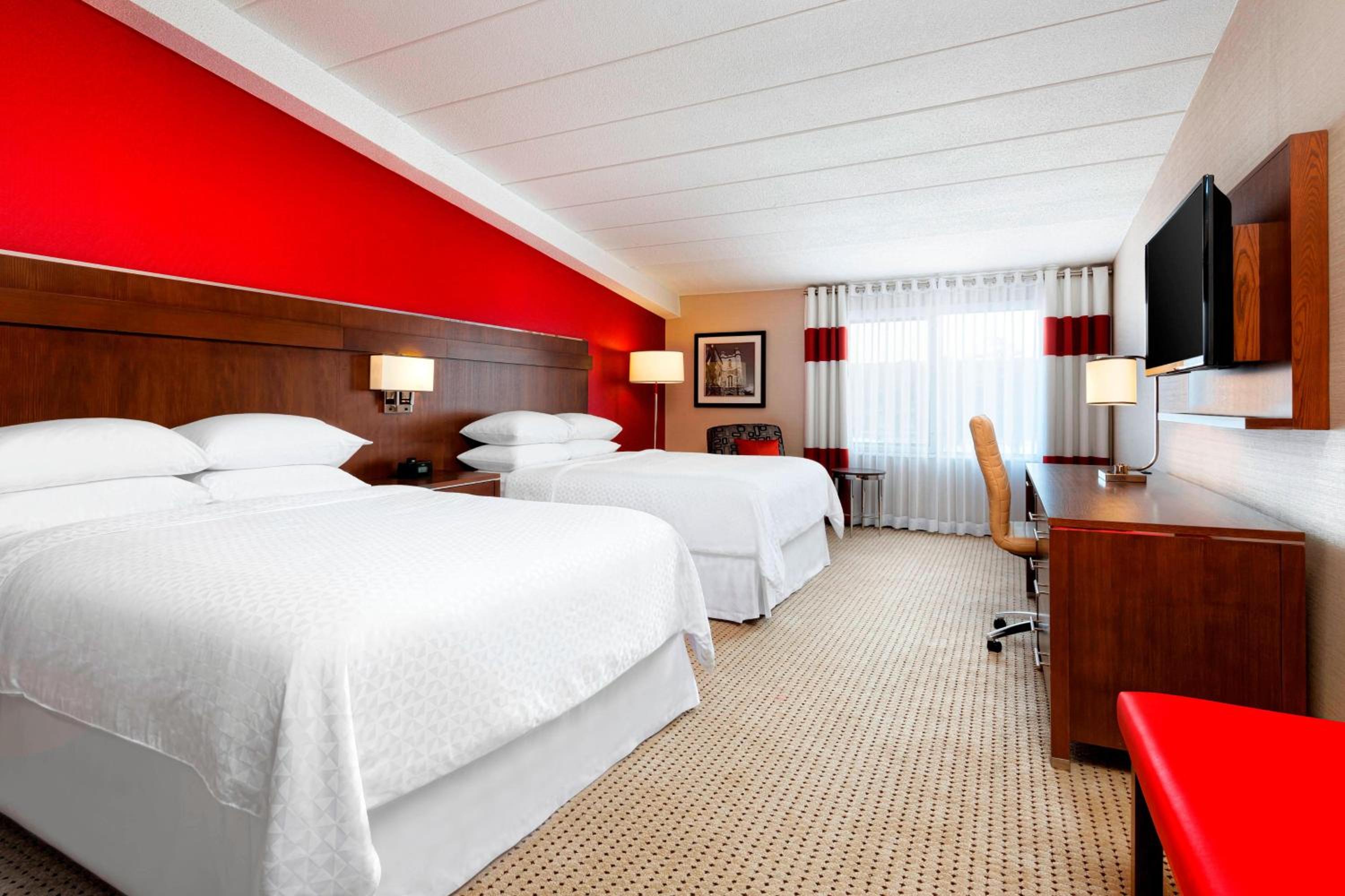 hotel room with two beds and a flat screen tv