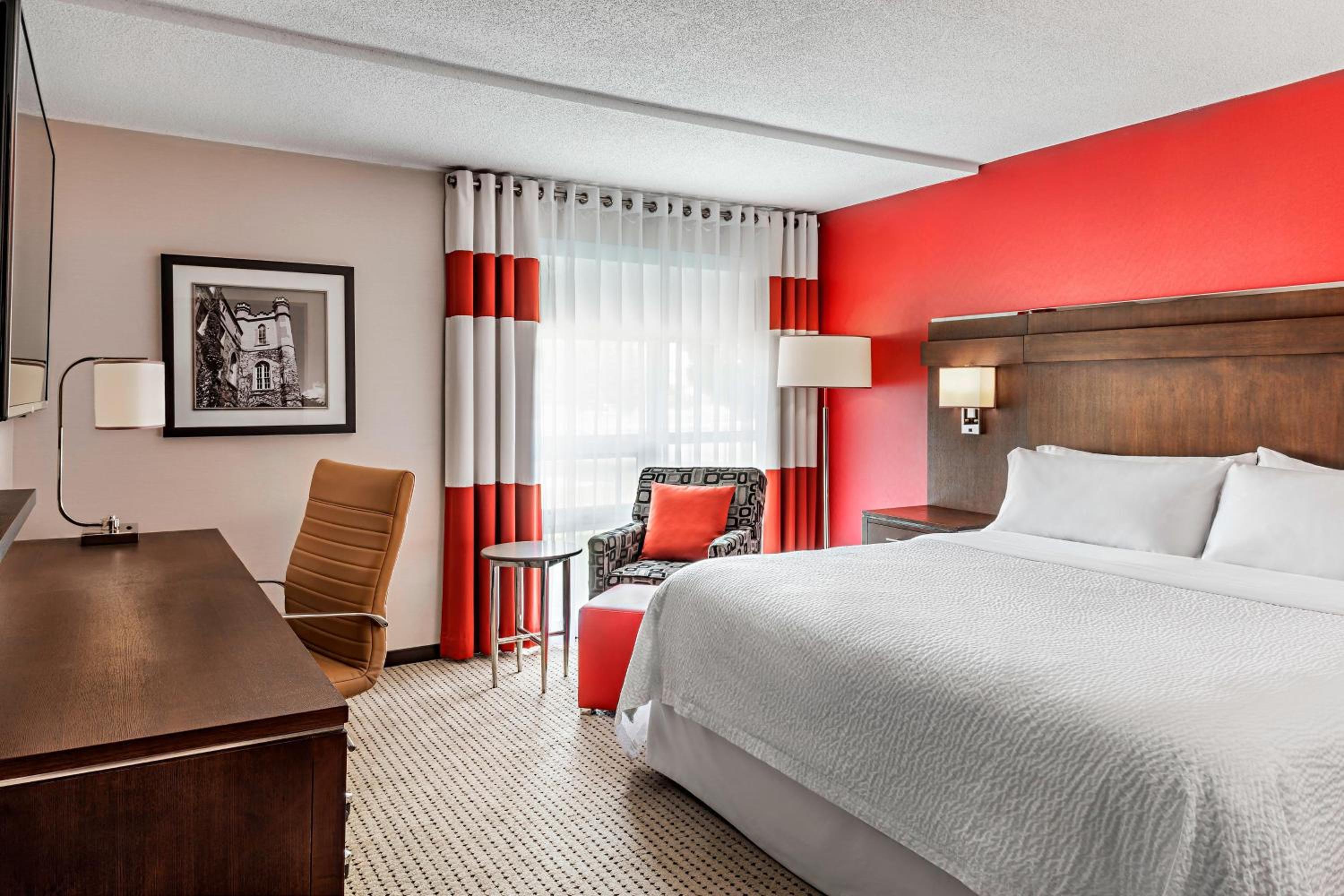hotel room with a king size bed and red walls