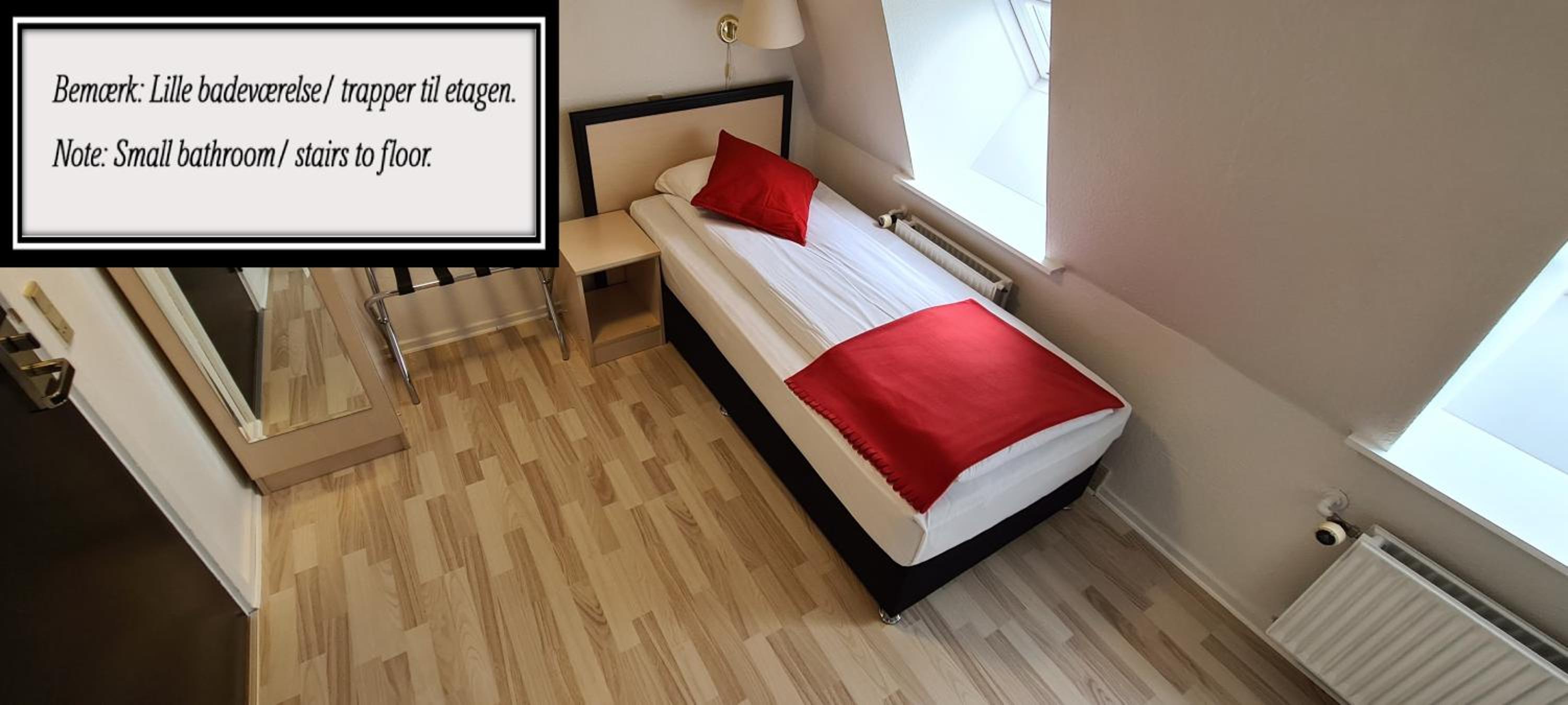 Economy single room, Small bathroom, note stairs to floor
