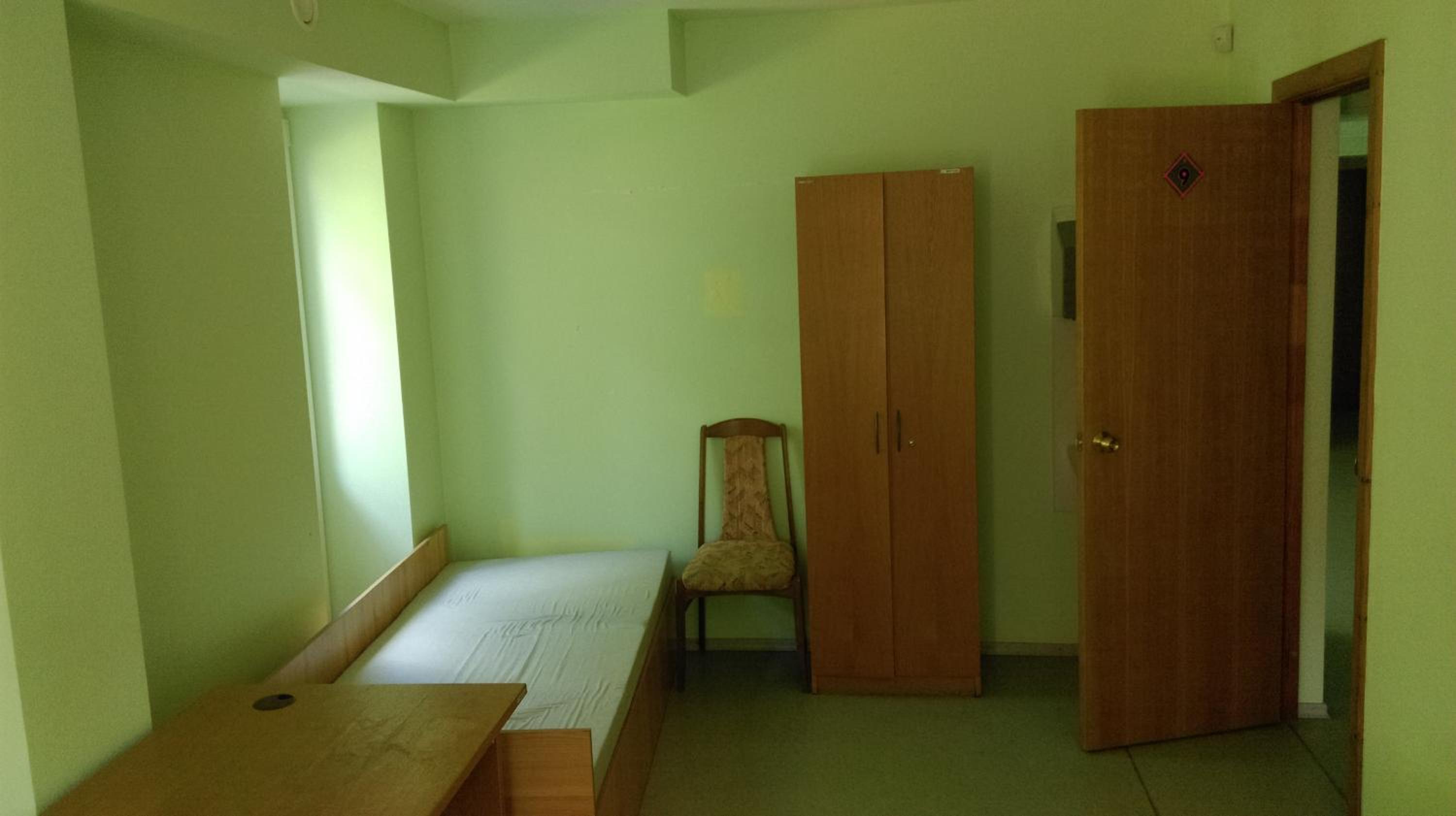 Single Bed In Dormitory Room