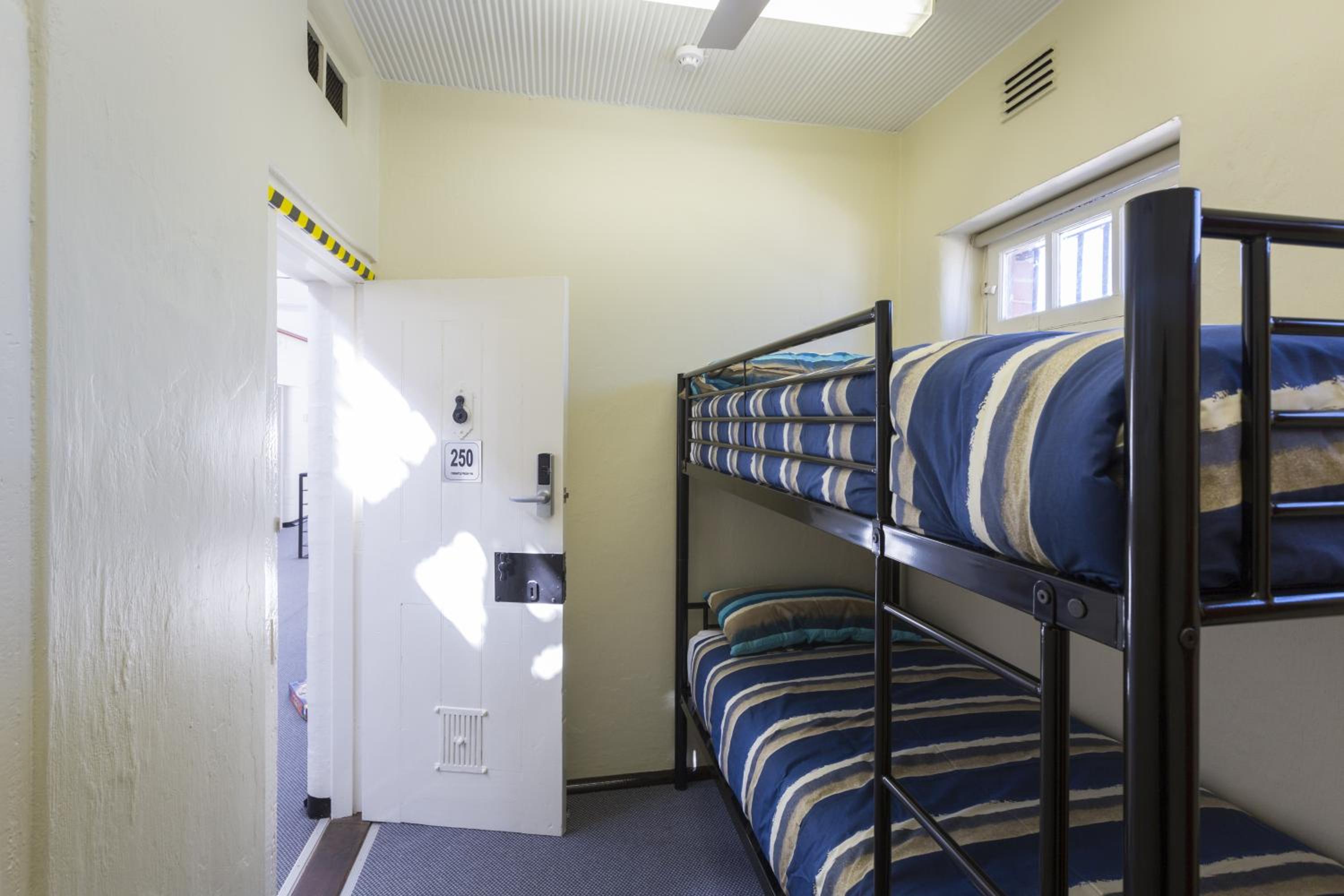 Small Twin Room with Shared Bathroom - Prison Cell