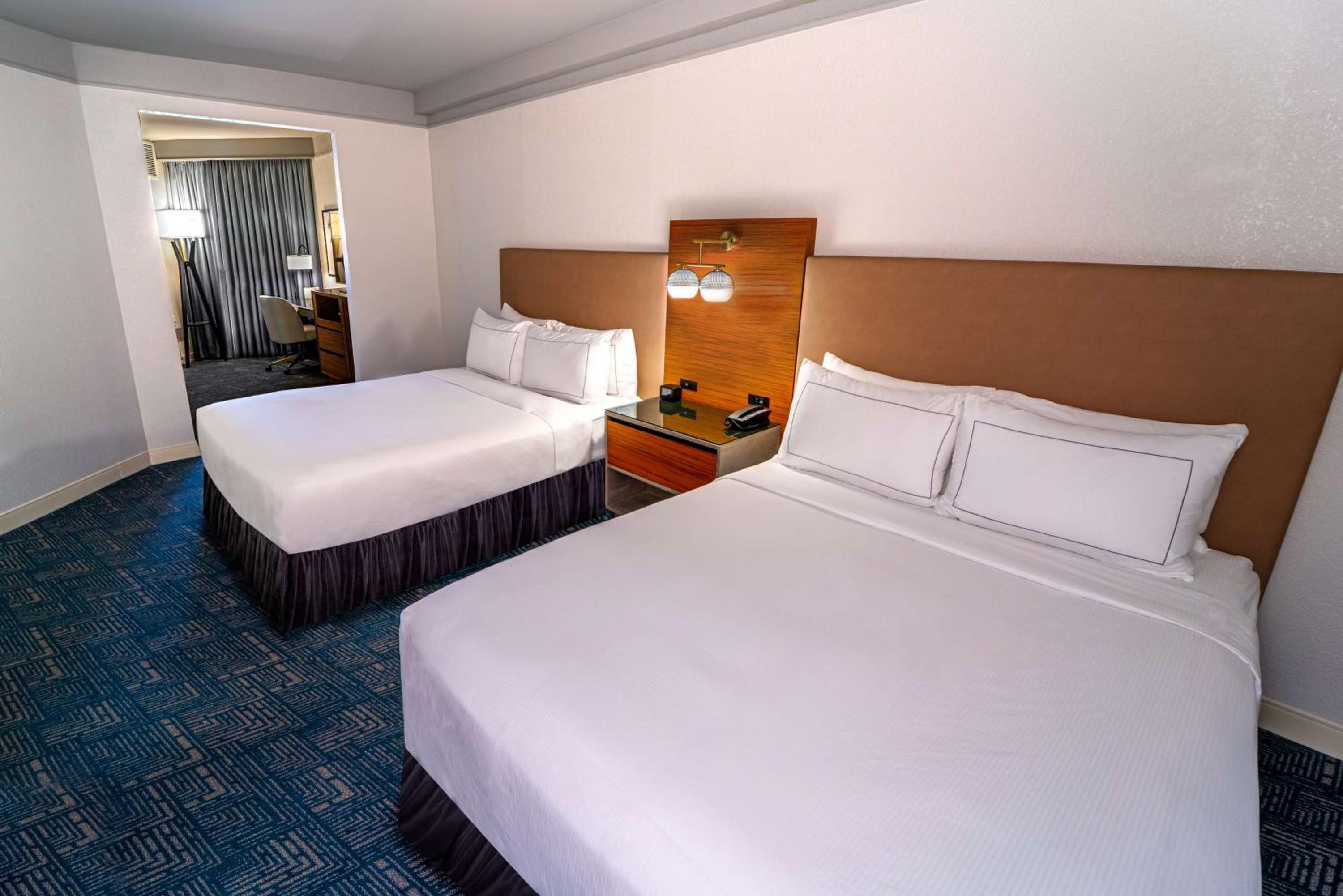 Queen Suite with Two Queen Beds and Sofa Bed - Photo 1