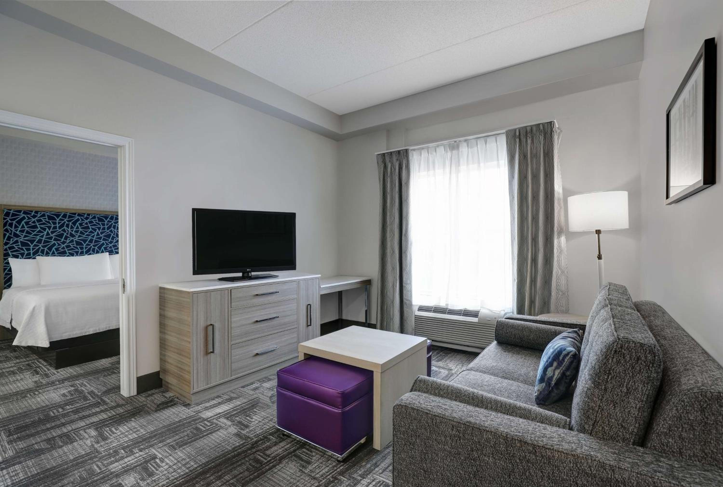 living room with a couch, coffee table, and television
