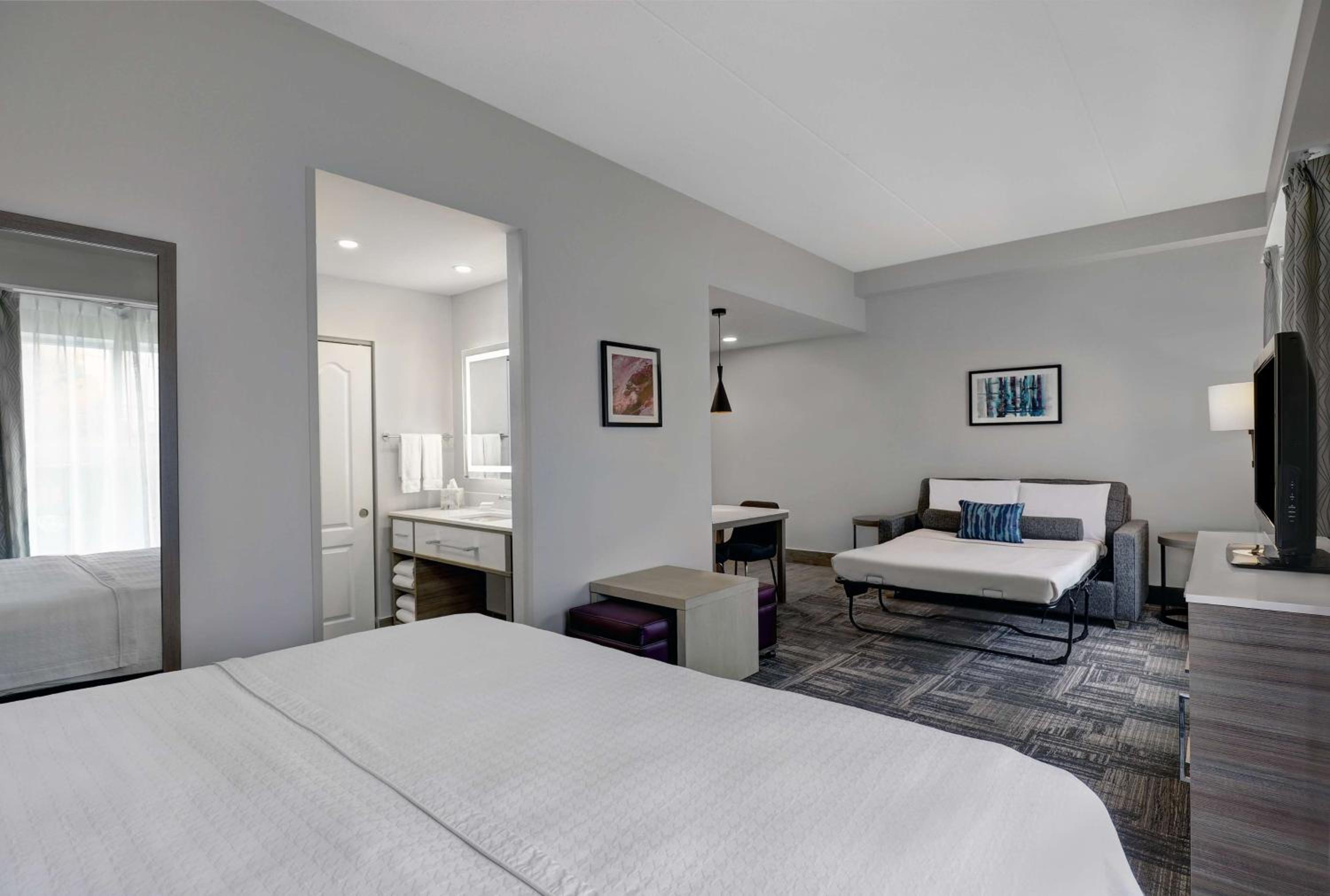 bedroom with a white bed and a flat screen tv