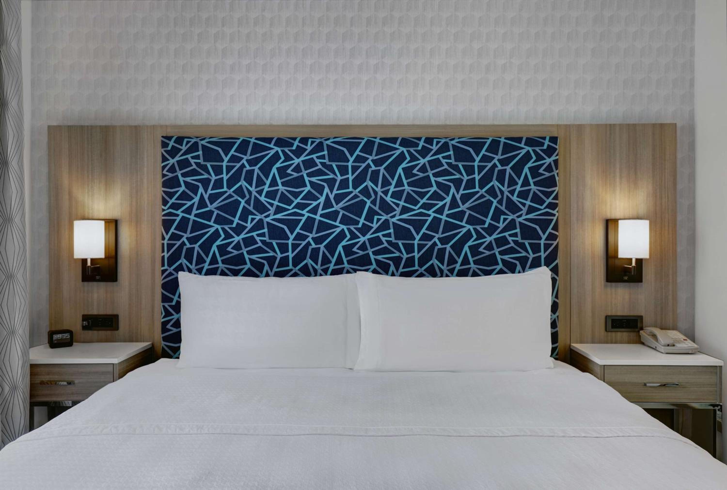 white bed with a blue headboard on top of it