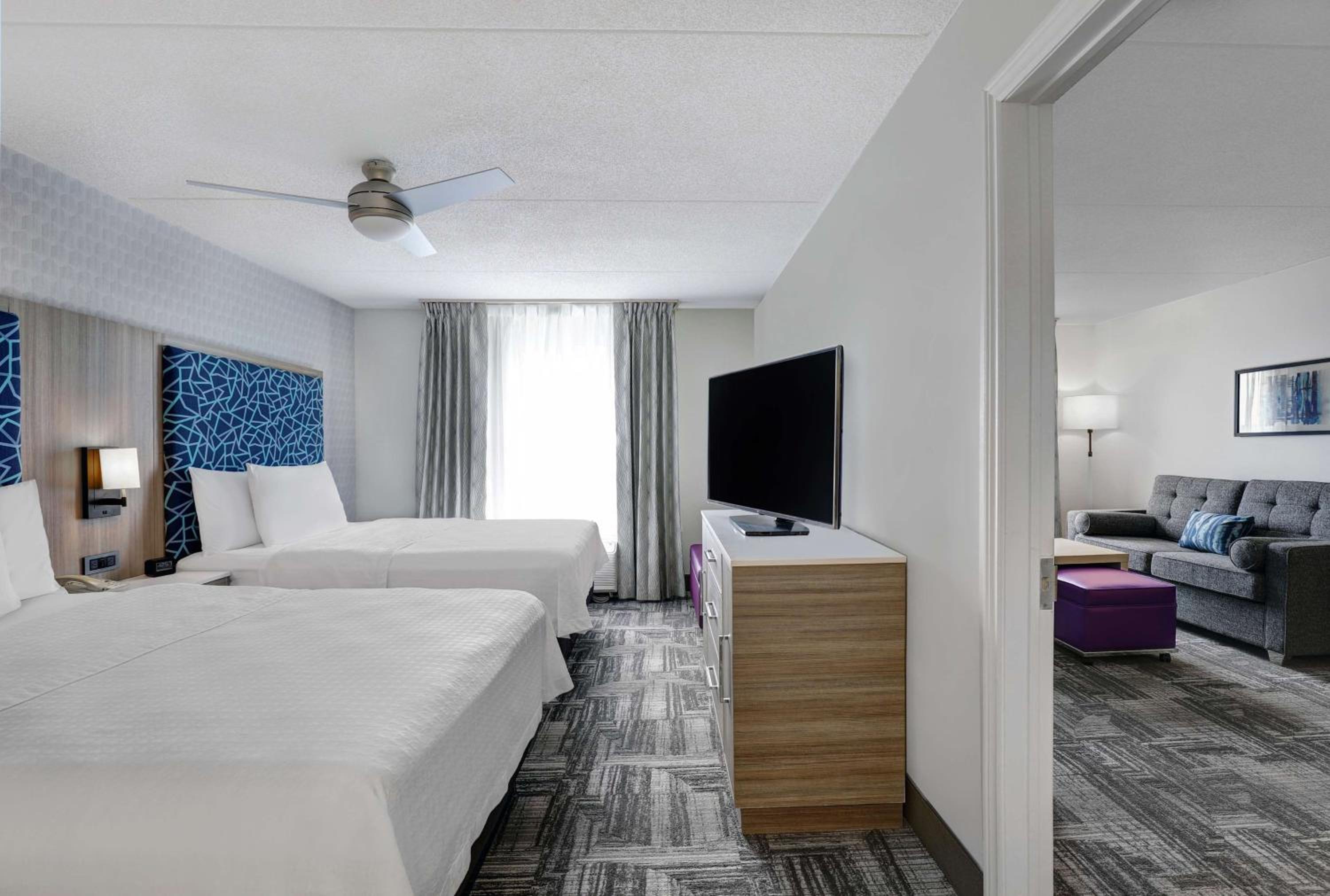 hotel room with two queen beds and a flat screen tv