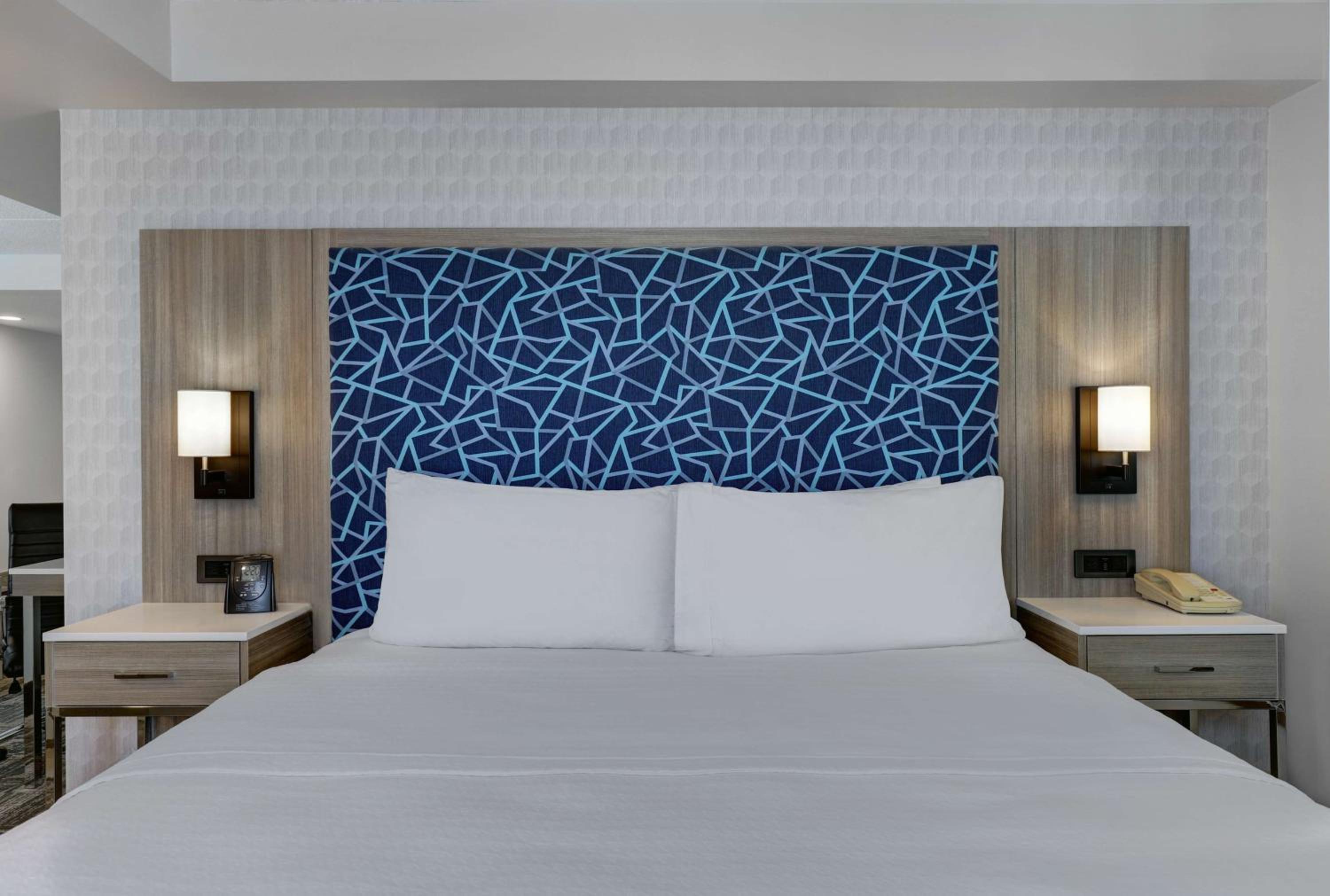 bed with white linens and a blue headboard