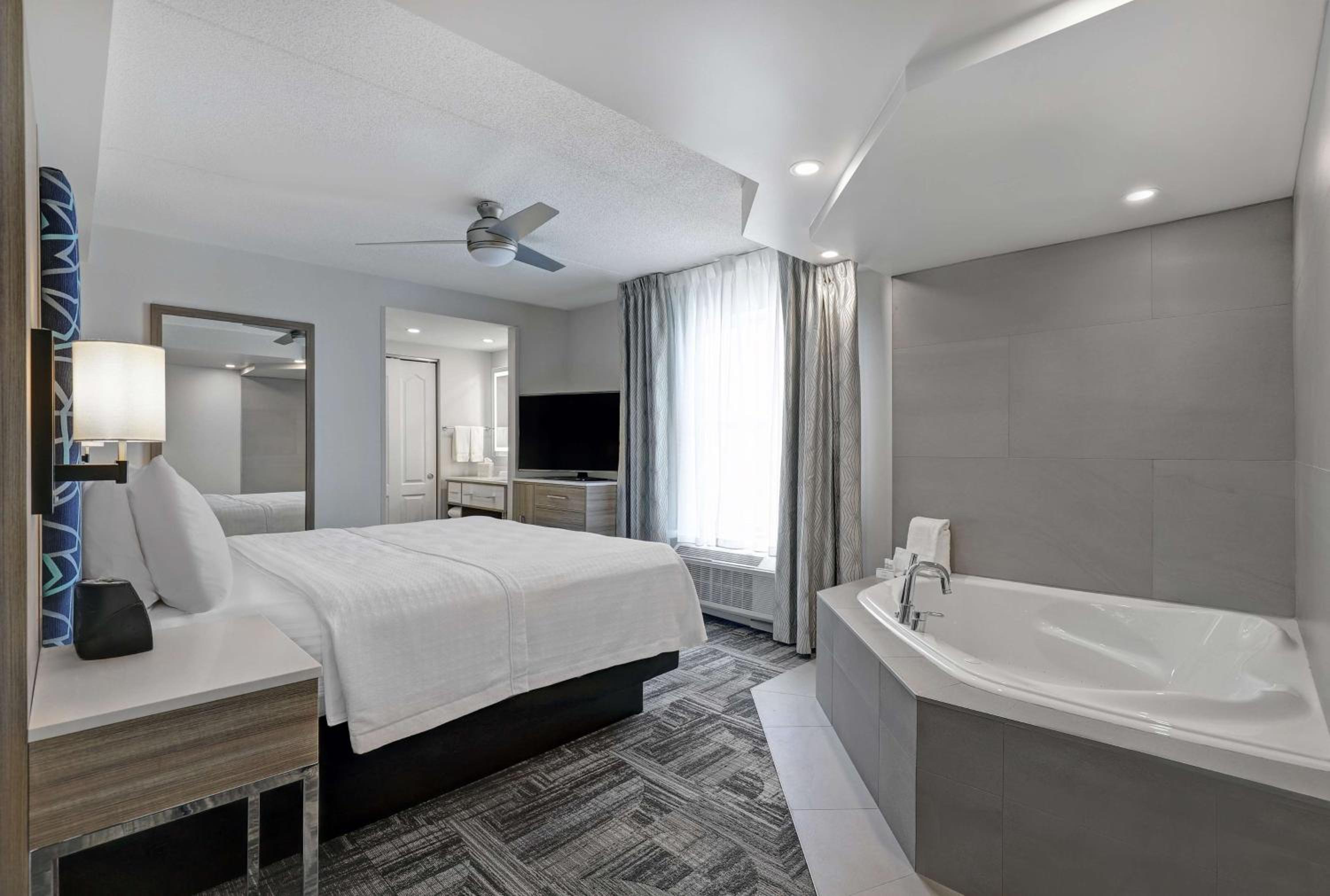 hotel room with a jacuzzi tub and flat screen tv