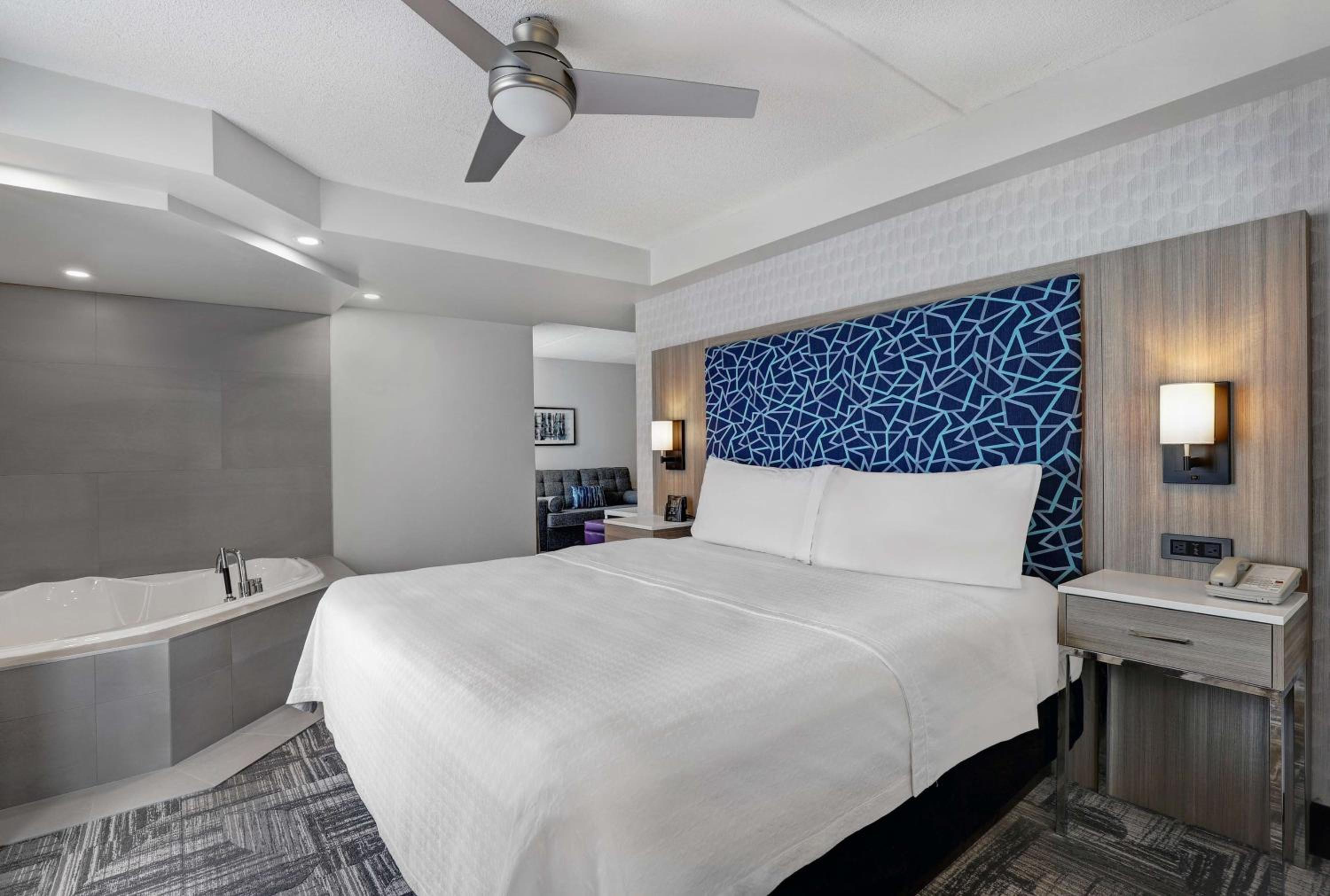 hotel room with a large bed and a jacuzzi tub