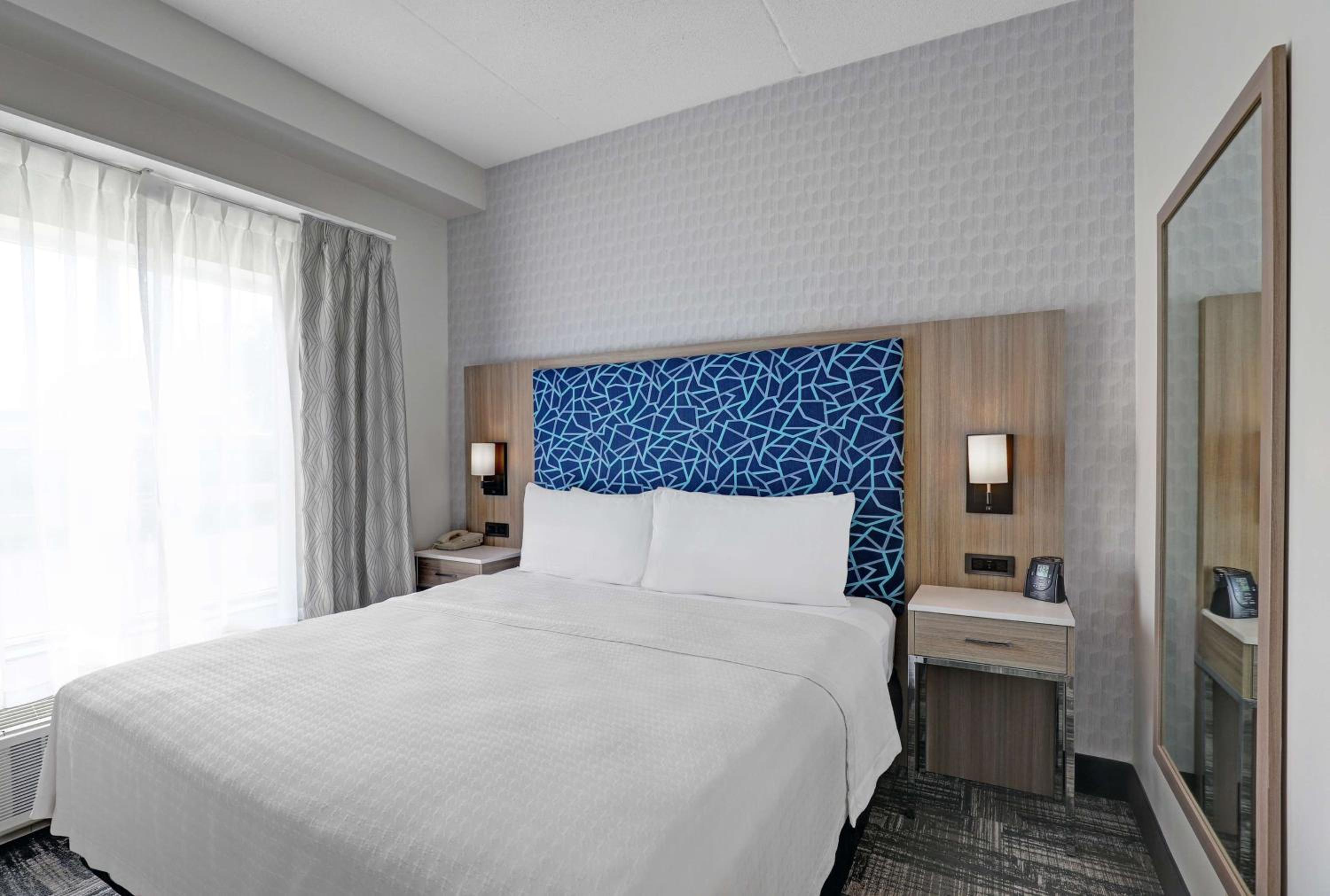 hotel room with a white bed and blue headboard
